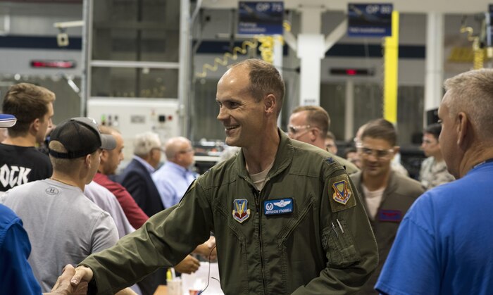 Col. Jefferson O'Donnell, 366th Fighter Wing commander, shakes hands with employees during a visit to a defense contractors factory, Aug. 3, 2017, in St. Louis, Mo. Airmen from Mountain Home Air Force Base, Idaho, were given the chance to talk with employees and thank them for their hard work and contribution to national defense. (U.S. Air Force photo by Senior Airman Jeremy L. Mosier)