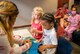 A mom fastens a button on her son's Thomas the Tank in the pediatric clinic waiting room before entering the Teddy Bear Clinic at Eglin Air Force Base, Aug. 4. Children took their stuffed animals and characters through eight clinic stations. Stations included registration, CPR, immunizations, nutrition, fitness and vital signs. The Pediatric Clinic hosted 127 children to educate them about hospital procedures and to demonstrate what they may expect if they need to see a doctor. (U.S. Air Force photo/Ilka Cole)