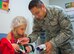 Senior Airman Gian Vera, 96 th Medical Group, aerospace medical services journeyman, shows five-year-old Loralei Clifton, how to take a temperature during the first Teddy Bear Clinic at Eglin Air Force Base, Aug. 4. Children took their stuffed animals and characters through eight clinic stations. Stations included registration, CPR, immunizations, nutrition, fitness and vital signs. The Pediatric Clinic hosted 127 children to educate them about hospital procedures and to demonstrate what they may expect if they need to see a doctor. (U.S. Air Force photo/Ilka Cole)