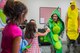 Capt. Lindsey Colgan, 96 th Medical Group chief of Clinical Dietetics gives four-year-old Layla Sherwood a first bump at the nutrition and fitness station during the first Teddy Bear Clinic at Eglin Air Force Base, Aug. 4. Children took their stuffed animals and characters through eight clinic stations. Stations included registration, CPR, immunizations, nutrition, fitness and vital signs. The Pediatric Clinic hosted 127 children to educate them about hospital procedures and to demonstrate what they may expect if they need to see a doctor. (U.S. Air Force photo/Ilka Cole)