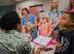 Airman First Class Naomi Crockett, a 96th Medical Group aerospace medical services apprentice 96th Medical Group, hands out certificates of Beary Good Health during the the first Teddy Bear Clinic at Eglin Air Force Base, Aug. 4. Children took their stuffed animals and characters through eight clinic stations. Stations included registration, CPR, immunizations, nutrition, fitness and vital signs. The Pediatric Clinic hosted 127 children to educate them about hospital procedures and to demonstrate what they may expect if they need to see a doctor. (U.S. Air Force photo/Ilka Cole)