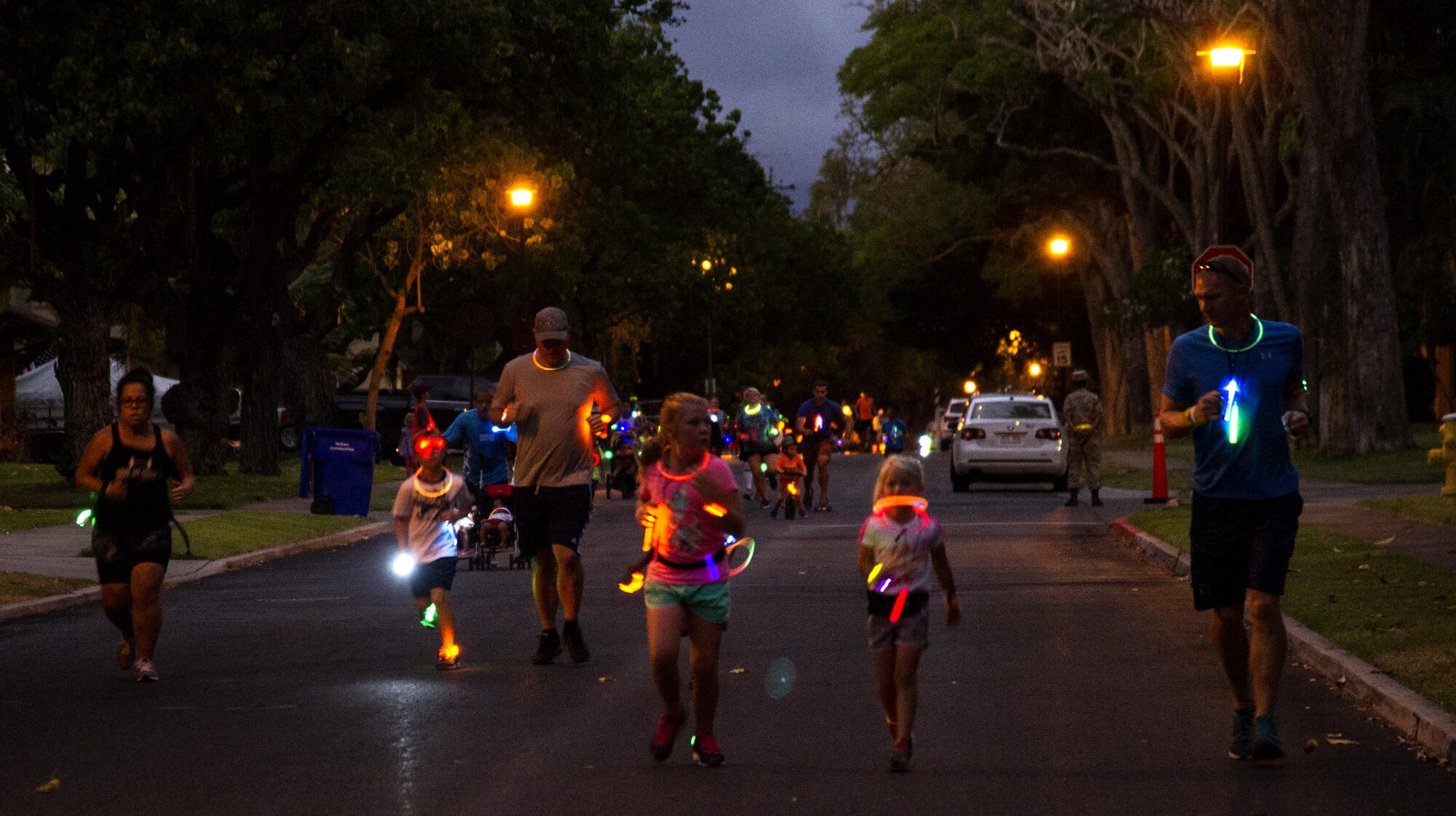 Servicemembers and their families participate in the Glow for Awareness family fun run at Joint Base Pearl Harbor-Hickam, Hawaii, Aug. 4, 2017.   The fun run was sponsored by the Hickam Sexual Assault Prevention and Response office to help bring the community together to focus on resiliency in a fun environment.  (U.S. Air Force photo by Tech. Sgt. Heather Redman)