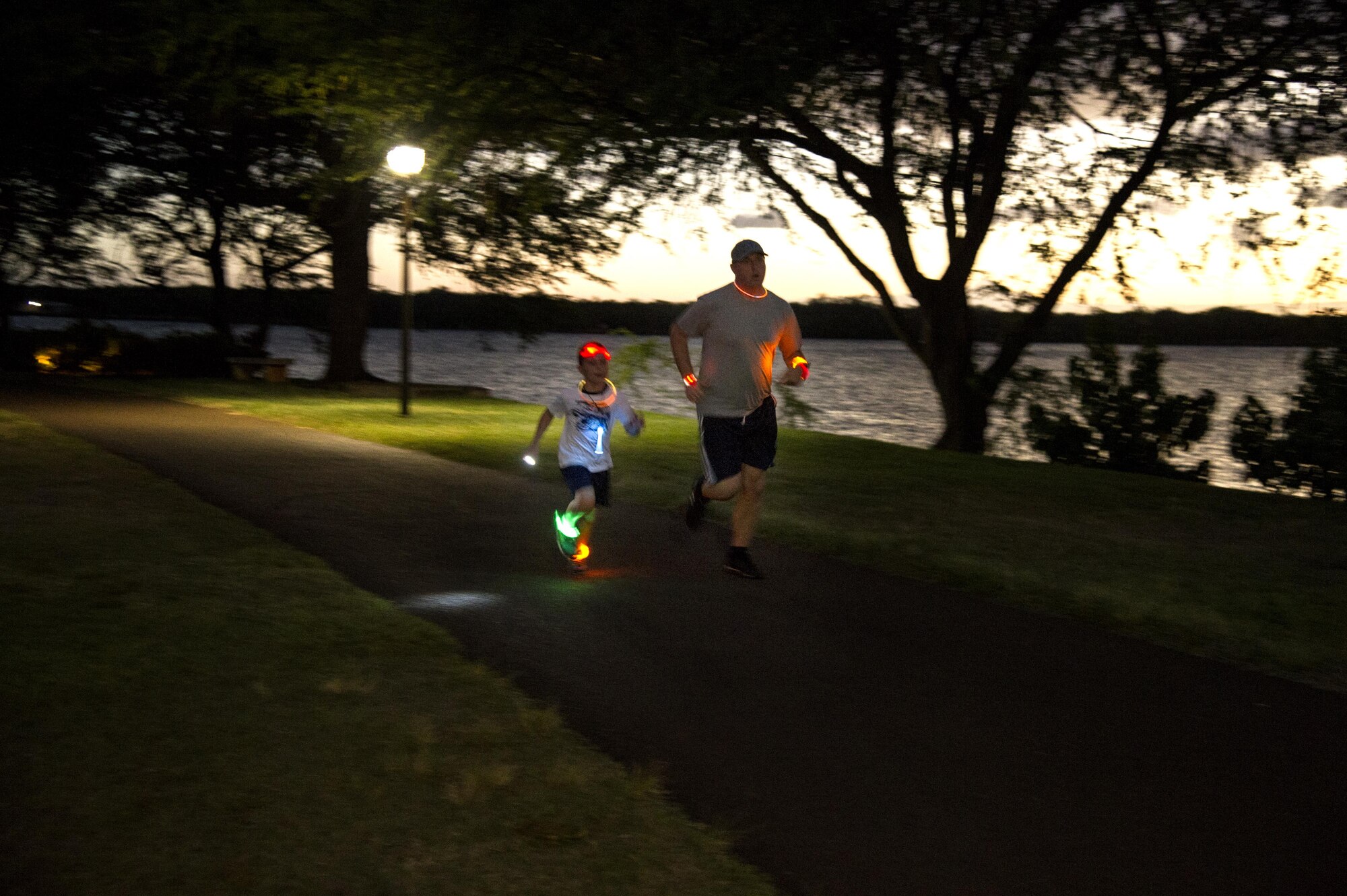Servicemembers and their families participate in the Glow for Awareness family fun run at Joint Base Pearl Harbor-Hickam, Hawaii, Aug. 4, 2017.   The fun run was sponsored by the Hickam Sexual Assault Prevention and Response office to help bring the community together to focus on resiliency in a fun environment.  (U.S. Air Force photo by Tech. Sgt. Heather Redman)