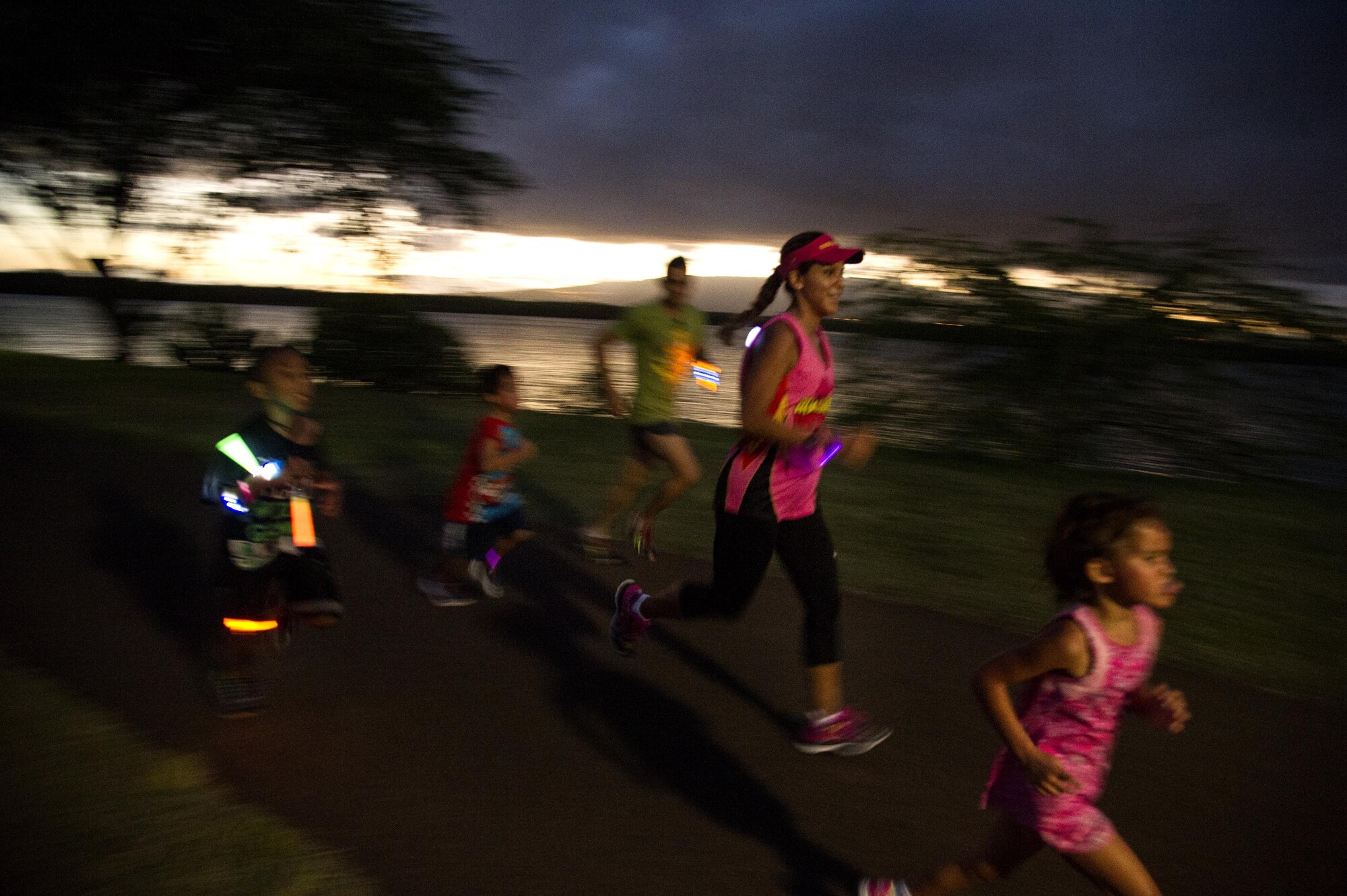 Servicemembers and their families participate in the Glow for Awareness family fun run at Joint Base Pearl Harbor-Hickam, Hawaii, Aug. 4, 2017.   The fun run was sponsored by the Hickam Sexual Assault Prevention and Response office to help bring the community together to focus on resiliency in a fun environment.  (U.S. Air Force photo by Tech. Sgt. Heather Redman)