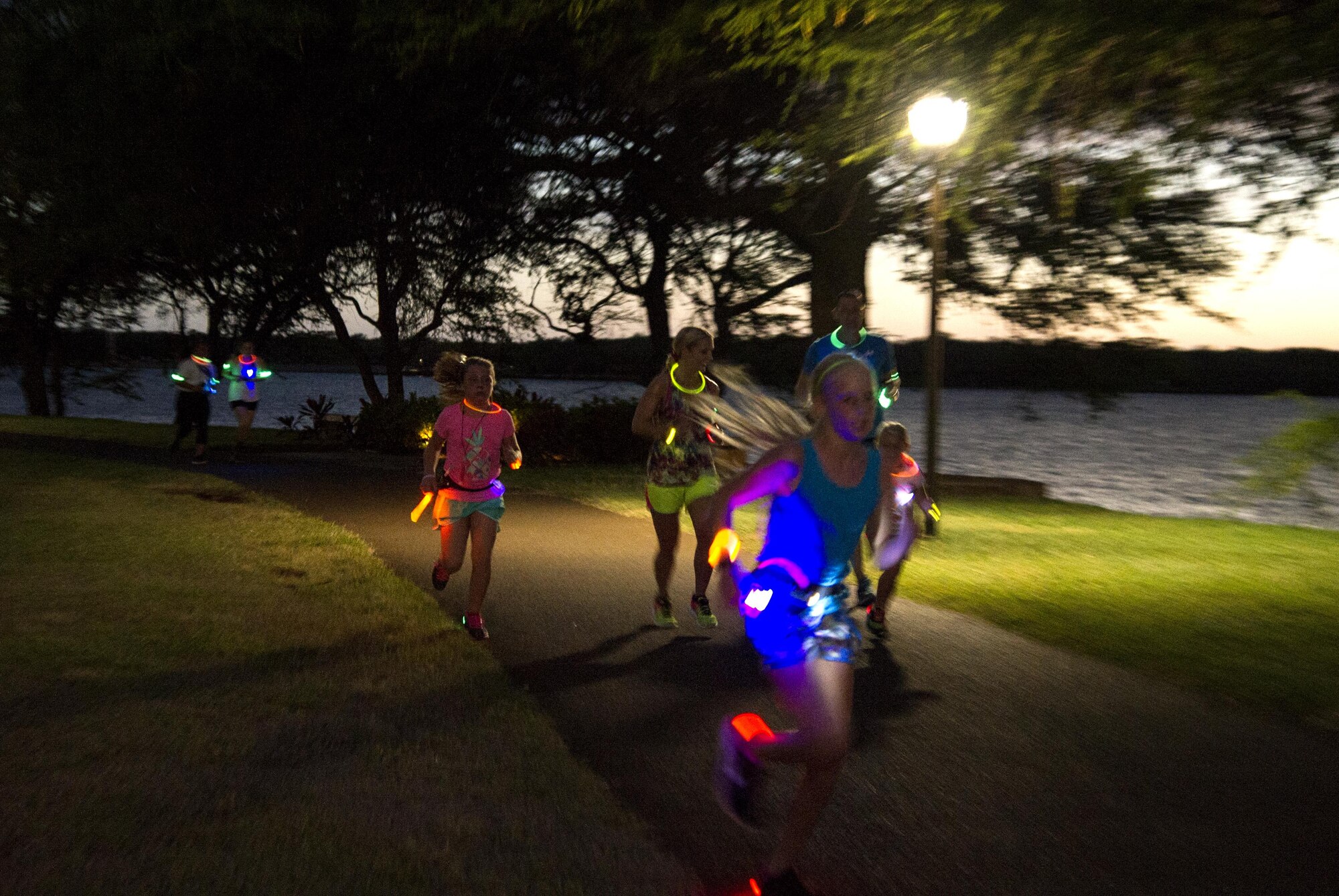 Servicemembers and their families participate in the Glow for Awareness family fun run at Joint Base Pearl Harbor-Hickam, Hawaii, Aug. 4, 2017.   The fun run was sponsored by the Hickam Sexual Assault Prevention and Response office to help bring the community together to focus on resiliency in a fun environment.  (U.S. Air Force photo by Tech. Sgt. Heather Redman)