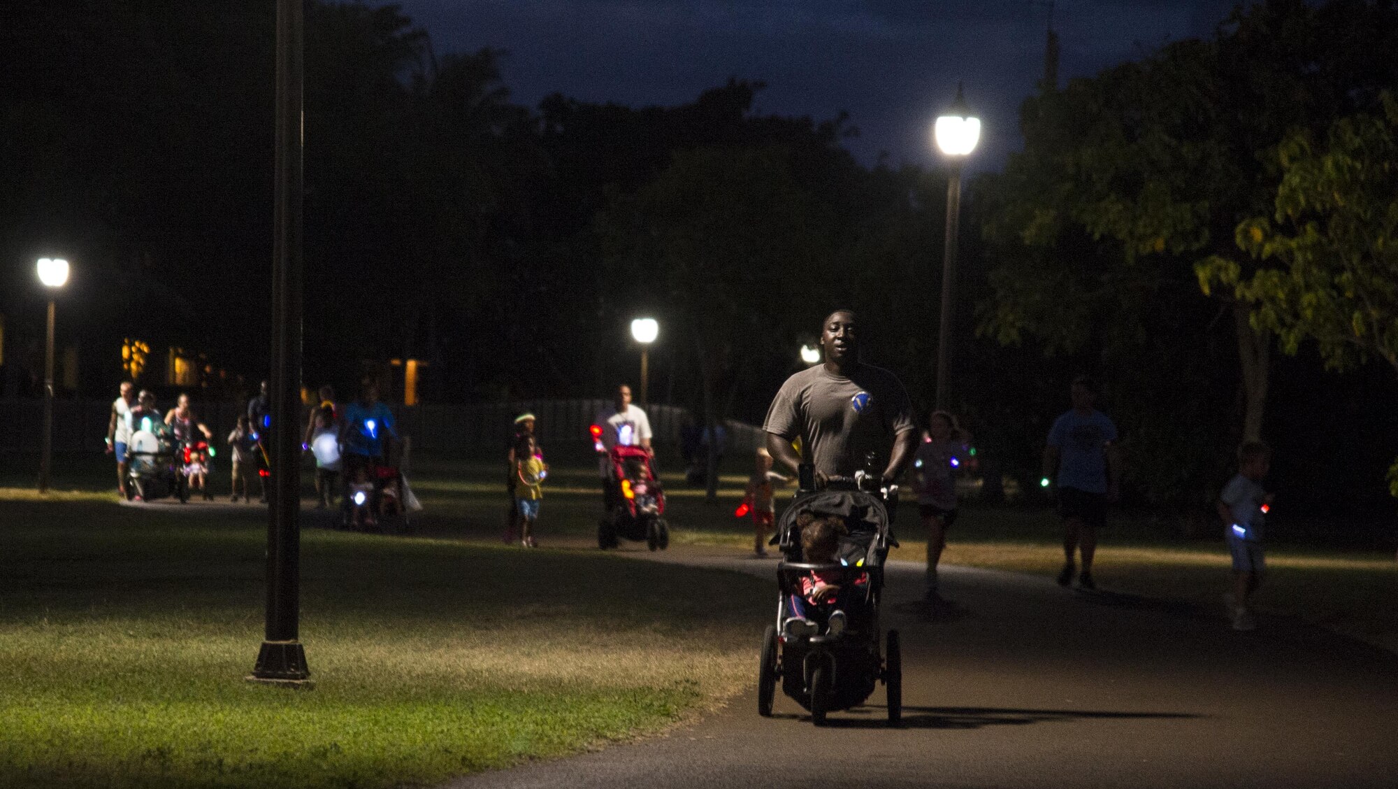 Servicemembers and their families participate in the Glow for Awareness family fun run at Joint Base Pearl Harbor-Hickam, Hawaii, Aug. 4, 2017.   The fun run was sponsored by the Hickam Sexual Assault Prevention and Response office to help bring the community together to focus on resiliency in a fun environment.  (U.S. Air Force photo by Tech. Sgt. Heather Redman)
