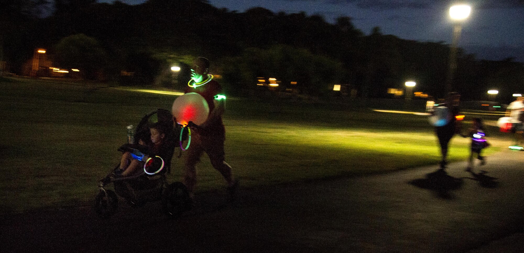 Servicemembers and their families participate in the Glow for Awareness family fun run at Joint Base Pearl Harbor-Hickam, Hawaii, Aug. 4, 2017.   The fun run was sponsored by the Hickam Sexual Assault Prevention and Response office to help bring the community together to focus on resiliency in a fun environment.  (U.S. Air Force photo by Tech. Sgt. Heather Redman)