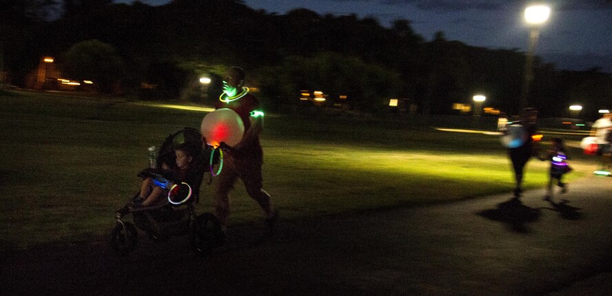 Servicemembers and their families participate in the Glow for Awareness family fun run at Joint Base Pearl Harbor-Hickam, Hawaii, Aug. 4, 2017.   The fun run was sponsored by the Hickam Sexual Assault Prevention and Response office to help bring the community together to focus on resiliency in a fun environment.  (U.S. Air Force photo by Tech. Sgt. Heather Redman)