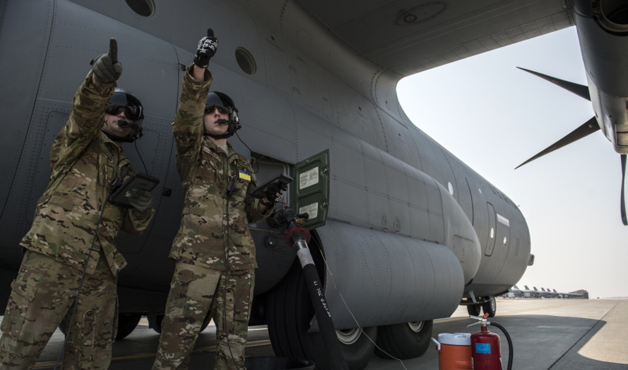 U.S. Air Force Airman 1st Class Tyler Holt, right, and Staff Sgt. George Childres, both 41st Airlift Squadron, loadmasters, walk through the process of hot defueling the C-130J Super Hercules during Exercise Mobility Guardian at Fairchild Air Force Base, Wash., Aug. 3, 2017. Hot defueling refers to off loading fuel while the engines are running. More than 3,000 Airmen, Soldiers, Sailors, Marines and international partners converged on the state of Washington in support of Mobility Guardian. The exercise is intended to test the abilities of the Mobility Air Forces to execute rapid global mobility missions in dynamic, contested environments. Mobility Guardian is Air Mobility Command's premier exercise, providing an opportunity for the Mobility Air Forces to train with joint and international partners in airlift, air refueling, aeromedical evacuation and mobility support. The exercise is designed to sharpen Airmen’s skills in support of combatant commander requirements. (U.S. Air Force photo by Tech. Sgt. Nathan Lipscomb)