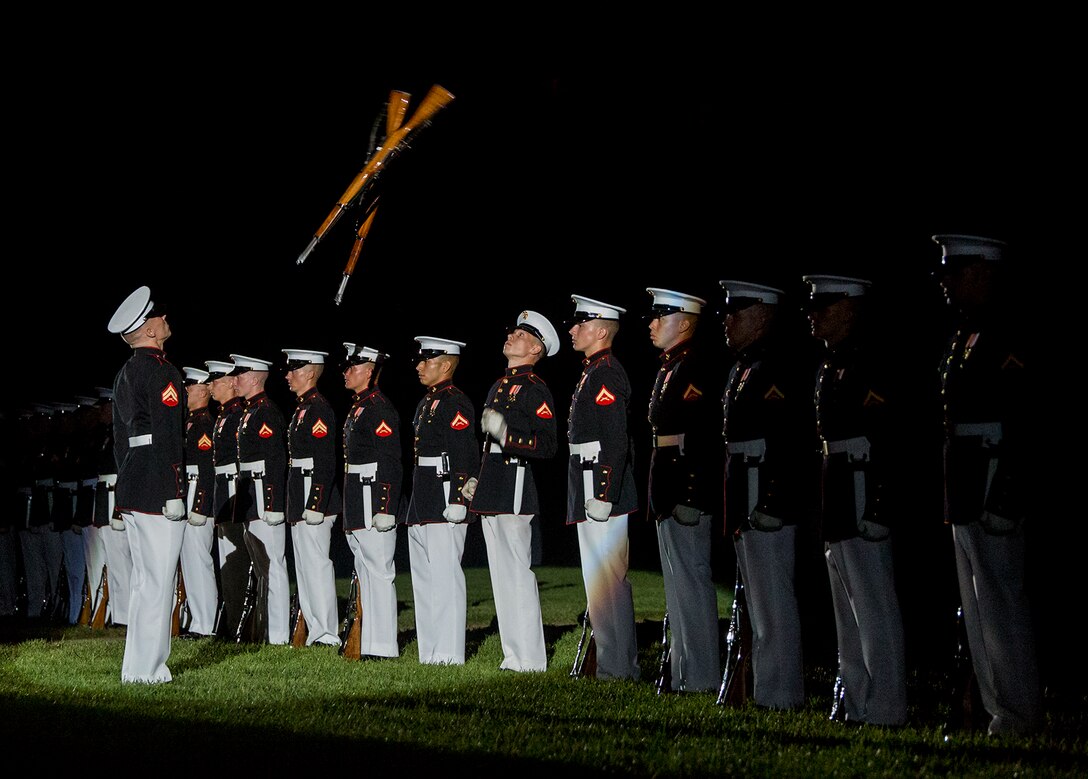 Corporal Jarris Wade, number one rifle inspector, U.S. Marine Corps Silent Drill Platoon, and Lance Cpl. Daniel Linebaugh , rifle inspection team, SDP, execute precision rifle drill movements during the Staff Noncommissioned Officer Evening Parade at Marine Barracks Washington D.C., Aug. 4, 2017. The guest of honor for the parade was retired Marine Corps Col. Archie Simpson, Guadalcanal veteran, and the hosting official was Lt. Gen. James B. Laster, director, Marine Corps Staff. (Official Marine Corps photo by Cpl. Robert Knapp/Released)