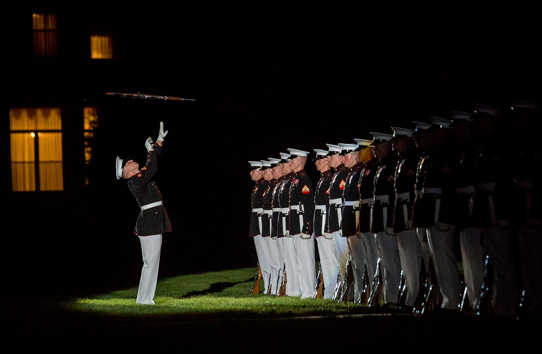 Corporal Jarris Wade, number one rifle inspector, U.S. Marine Corps Silent Drill Platoon, executes a rifle inspection during the Staff Noncommissioned Officer Evening Parade at Marine Barracks Washington D.C., Aug. 4, 2017. The guest of honor for the parade was retired Marine Corps Col. Archie Simpson, Guadalcanal veteran, and the hosting official was Lt. Gen. James B. Laster, director, Marine Corps Staff. (Official Marine Corps photo by Cpl. Robert Knapp/Released)