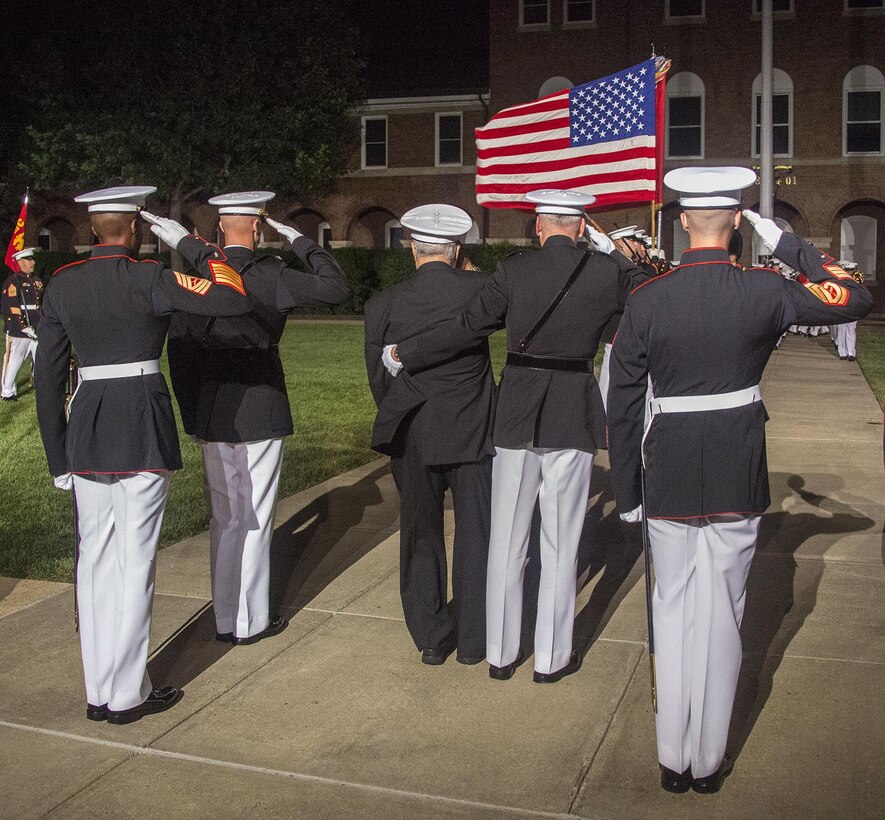 Marines of the parade staff, the guest of honor, and hosting official render honors to the National Ensign as a part of “pass and review” during the Staff Noncommissioned Officer Evening Parade at the Barracks, Aug. 4, 2017. The guest of honor for the parade was retired Marine Corps Col. Archie Simpson, Guadalcanal veteran, and the hosting official was Lt. Gen. James B. Laster, director, Marine Corps Staff. (Official Marine Corps photo by Cpl. Robert Knapp/Released)