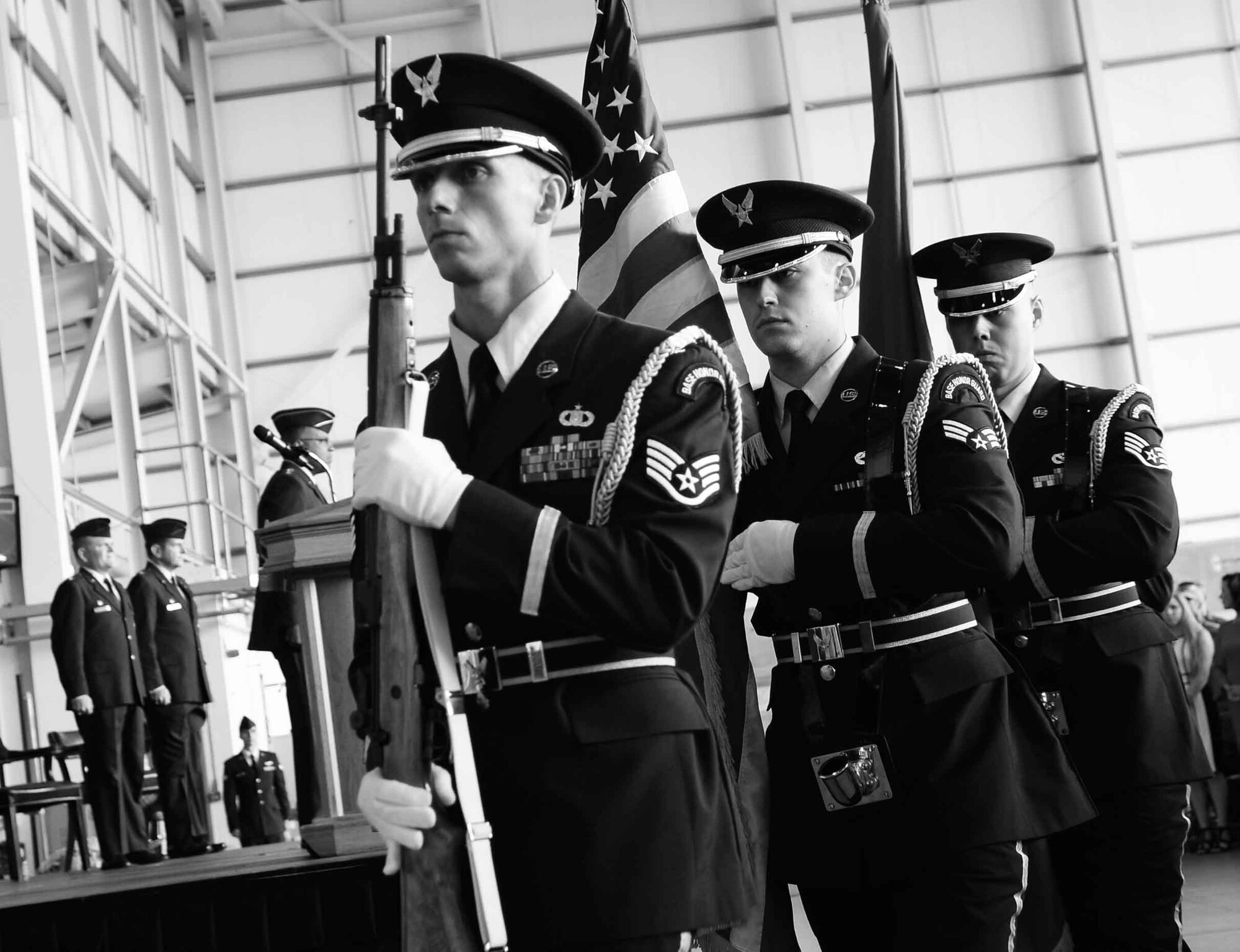 Team Mildenhall honor guardsmen exit after presenting the colors July 21, 2017, during a change of command ceremony on RAF Mildenhall, England. While progressing in their respective career fields, the RAF Mildenhall honor guard members also commit about 16 hours of training and up to 30 hours of details a month. The details include change of command, retirements and funeral ceremonies. (U.S. Air Force photo by Airman 1st Class Luke Milano)