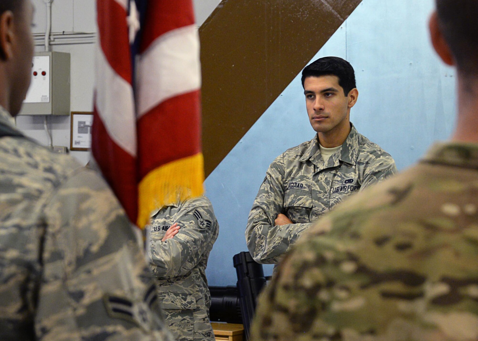 U.S. Air Force Senior Airman Alejandro Aguiar oversees honor guard members rehearsing the presenting of the colors July 28, 2017, on RAF Mildenhall, England. Aguiar is one of three trainers on the Team Mildenhall honor guard team. While carrying out honor guard details and training, Aguiar is also fulfilling his duties as a 100th Maintenance Squadron aircraft structural maintainer. (U.S. Air Force photo by Senior Airman Justine Rho)