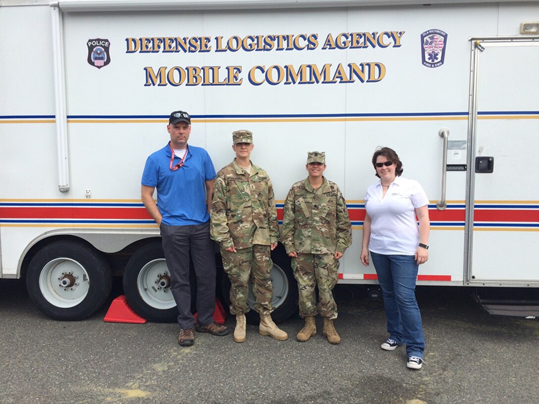 DLA Energy Americas East at Houston team pose for a photo by the DLA Mobile Command Vehicle