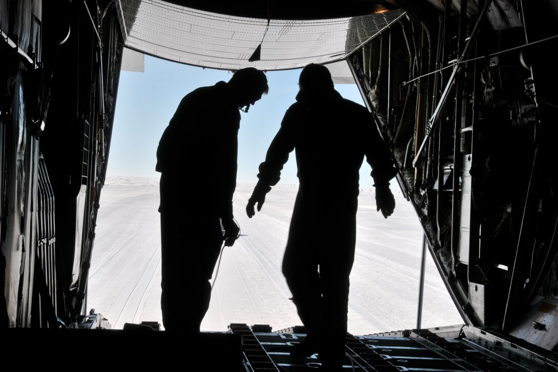 Airmen prepare a combat offload from an LC-130 aircraft at Raven Camp.