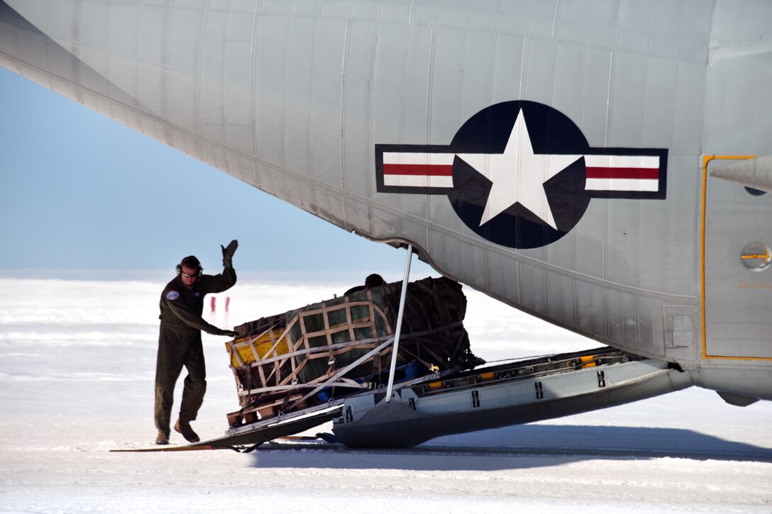 An airman loads a pallet onto an LC-130 aircraft at Raven Camp.