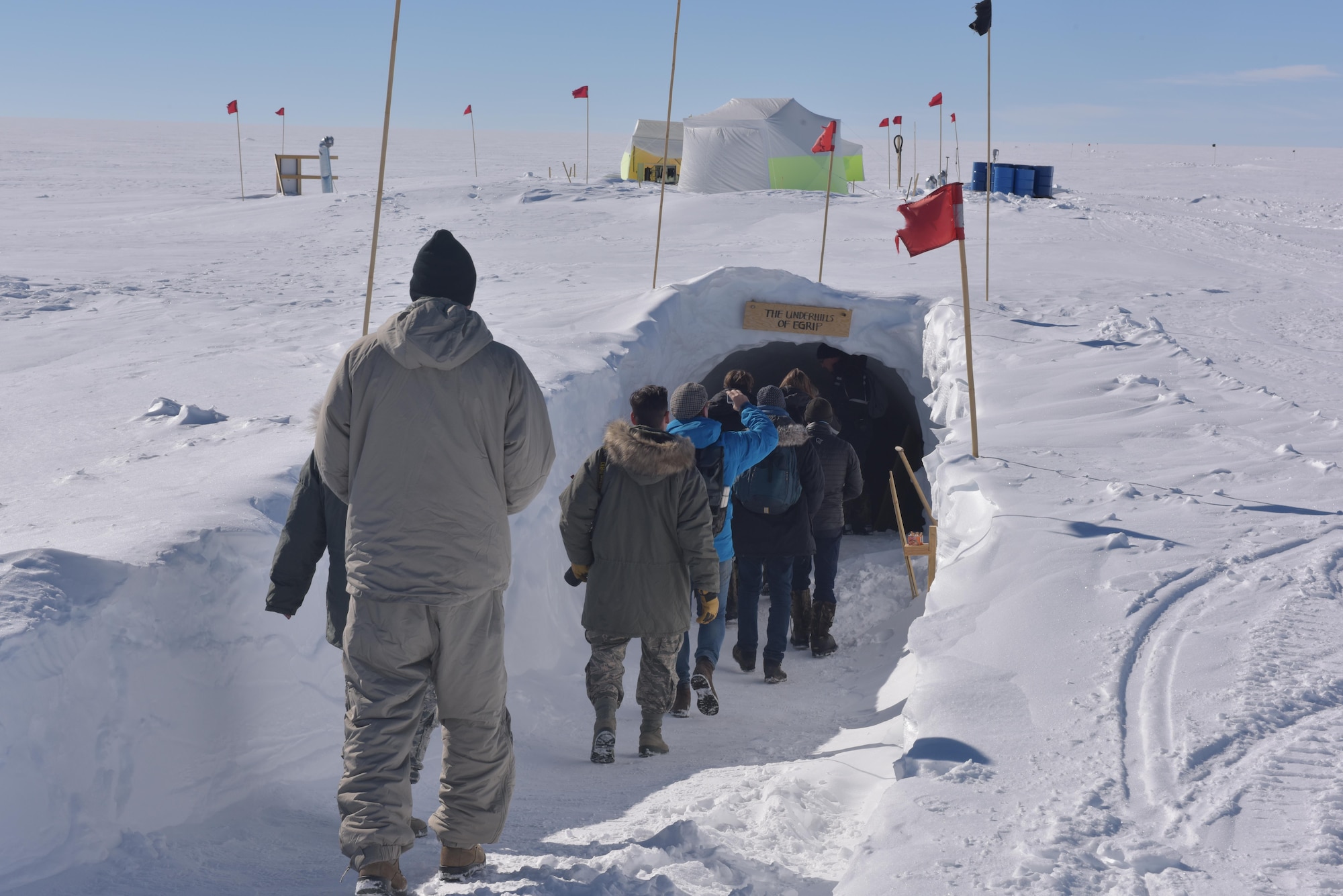 Journalists get a look inside of the East GRIP underground station July 29, 2017. Here, scientists drill through the Northeast Greenland Ice Stream to receive ice core samples to study. Journalists had a chance to visit during a mission the wing was conducting to provide cargo to the camp. (U.S. Air National Guard photo by Senior Master Sgt. William Gizara/Released)