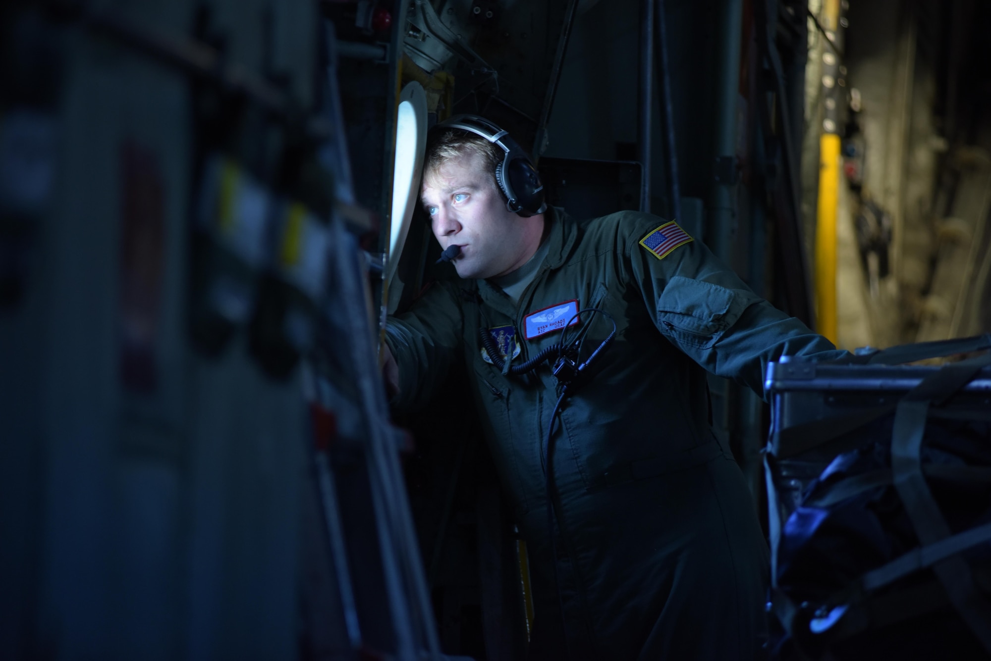 OVER GREENLAND - Airman 1st Class Ryan Rhoades, a student loadmaster with the 139th Airlift Squadron, on a flight to East GRIP (East Greenland Ice-core Project) from Kangerlussuaq, Greenland, on July 29, 2017. That was the 13th mission the 109th Airlift Wing made to East GRIP this season to transport cargo and scientists.  (U.S. Air National Guard photo by Senior Airman Jamie Spaulding/Released)