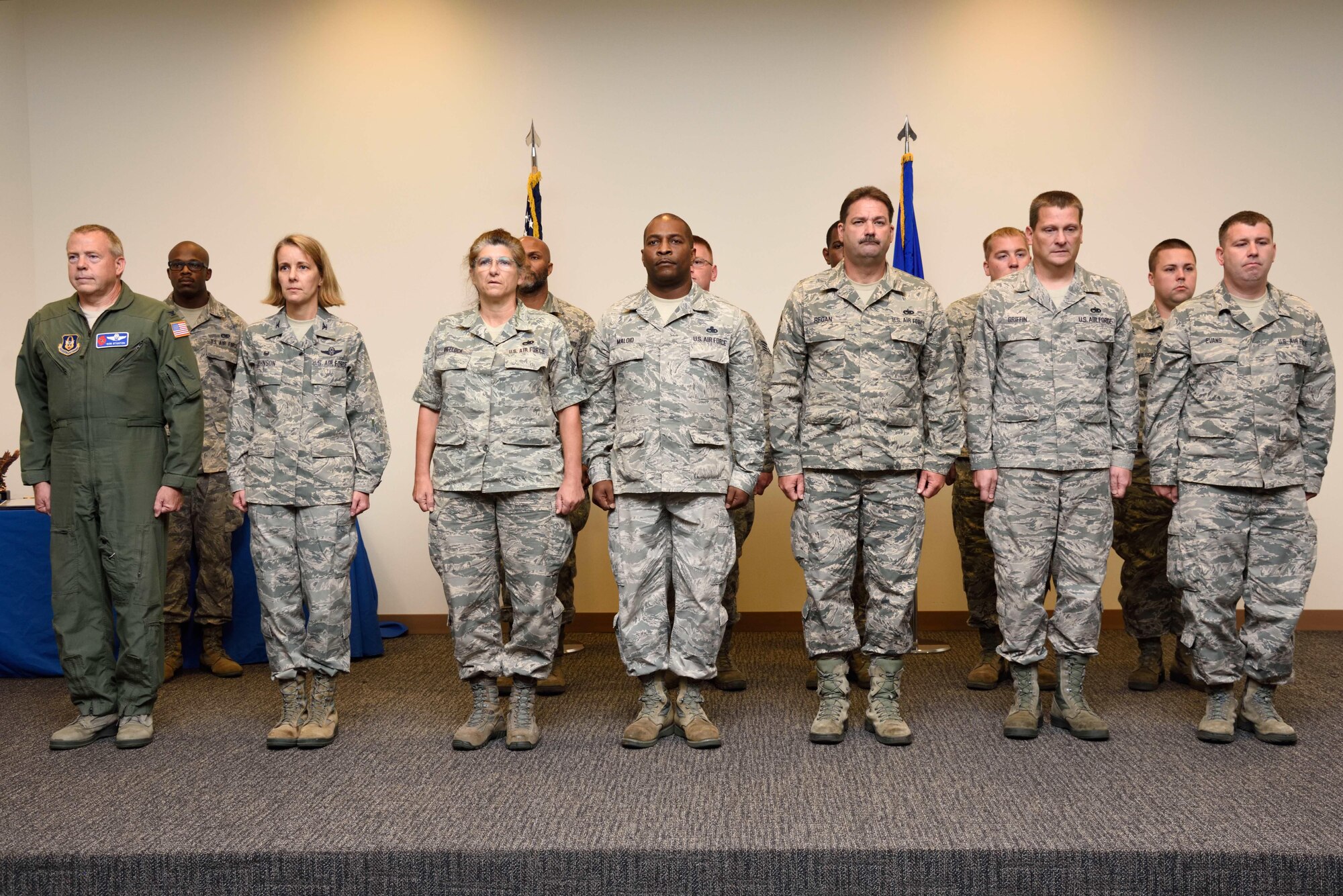 Col. Jennie Johnson, 403rd Wing commander and Col. Robert Stanton, 403rd Wing vice commander, stand on stage with members of the 403rd Maintenance Squadron during a commander's call Aug. 6, 2017 at Keesler Air Force Base, Mississippi. The 403rd MXS members were each presented with an Air Force Achievement Medal for their work in completing an engine modification to the 403rd Wing's entire fleet of aircraft. (U.S. Air Force photo/Tech Sgt. Ryan Labadens)