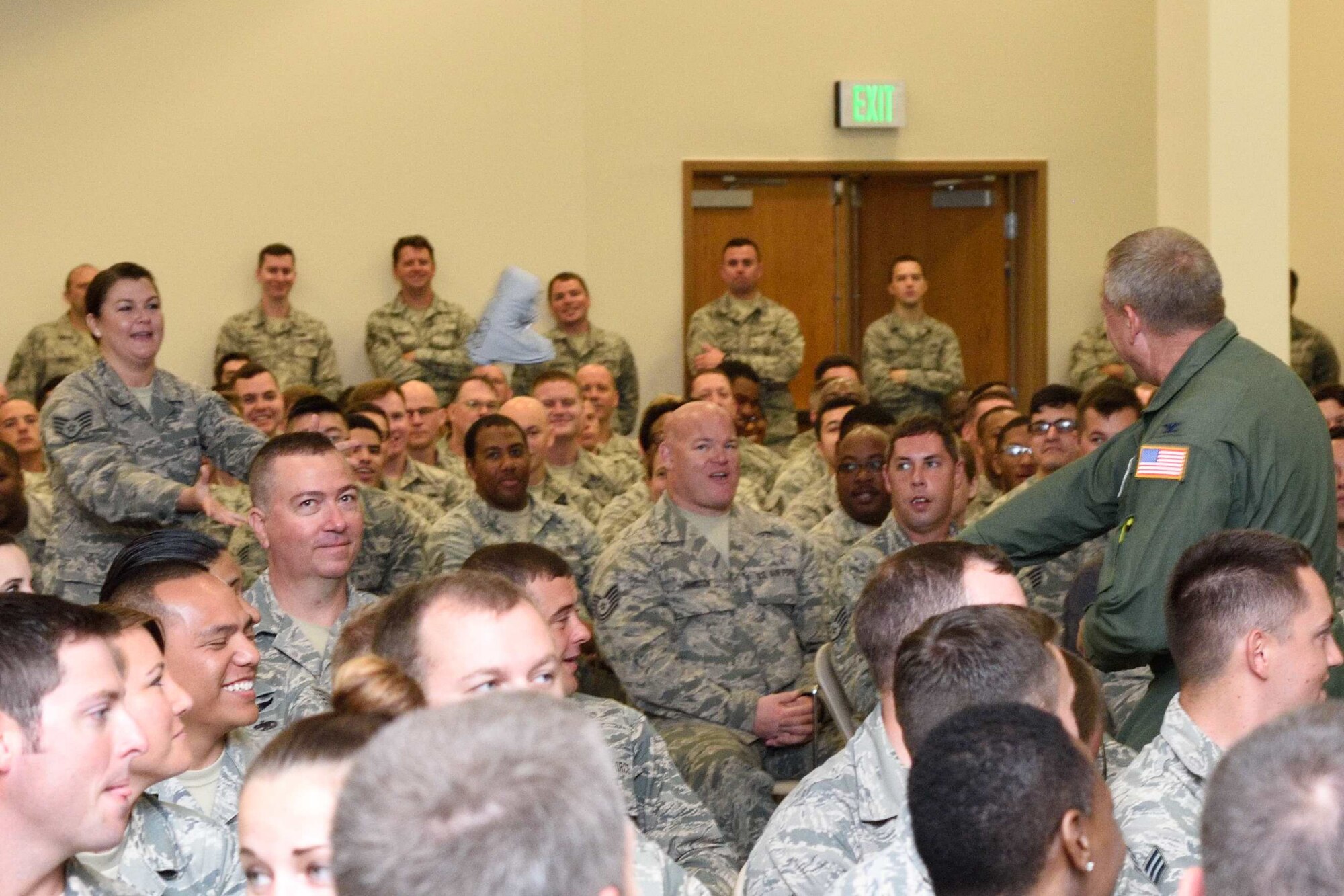 Col. Robert Stanton, 403rd Wing vice commander, throws a fitness 100 t-shirt to Staff. Sgt. Lyndsie Vitolo, 403rd Aeromedical Staging Squadron, during a commander's call Aug. 6, 2017 at Keesler Air Force Base, Mississippi. (U.S. Air Force photo/Tech. Sgt. Ryan Labadens)