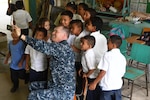 Navy Chaplain (Lt. Cmdr.) Clifford Rutledge takes a selfie with students at República de Colombia Elementary School in Silin, Honduras, Aug. 1, 2017. Sailors participated in a community relations project as part of Southern Partnership Station 2017, a U.S. Navy deployment focused on subject-matter-expert exchanges with partner-nation militaries and security forces in Central and South America. Navy photo by Petty Officer 1st Class Jeremy Starr