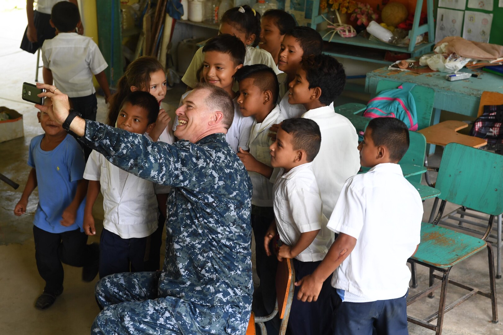 Navy Chaplain (Lt. Cmdr.) Clifford Rutledge takes a selfie with students at República de Colombia Elementary School in Silin, Honduras, Aug. 1, 2017. Sailors participated in a community relations project as part of Southern Partnership Station 2017, a U.S. Navy deployment focused on subject-matter-expert exchanges with partner-nation militaries and security forces in Central and South America. Navy photo by Petty Officer 1st Class Jeremy Starr