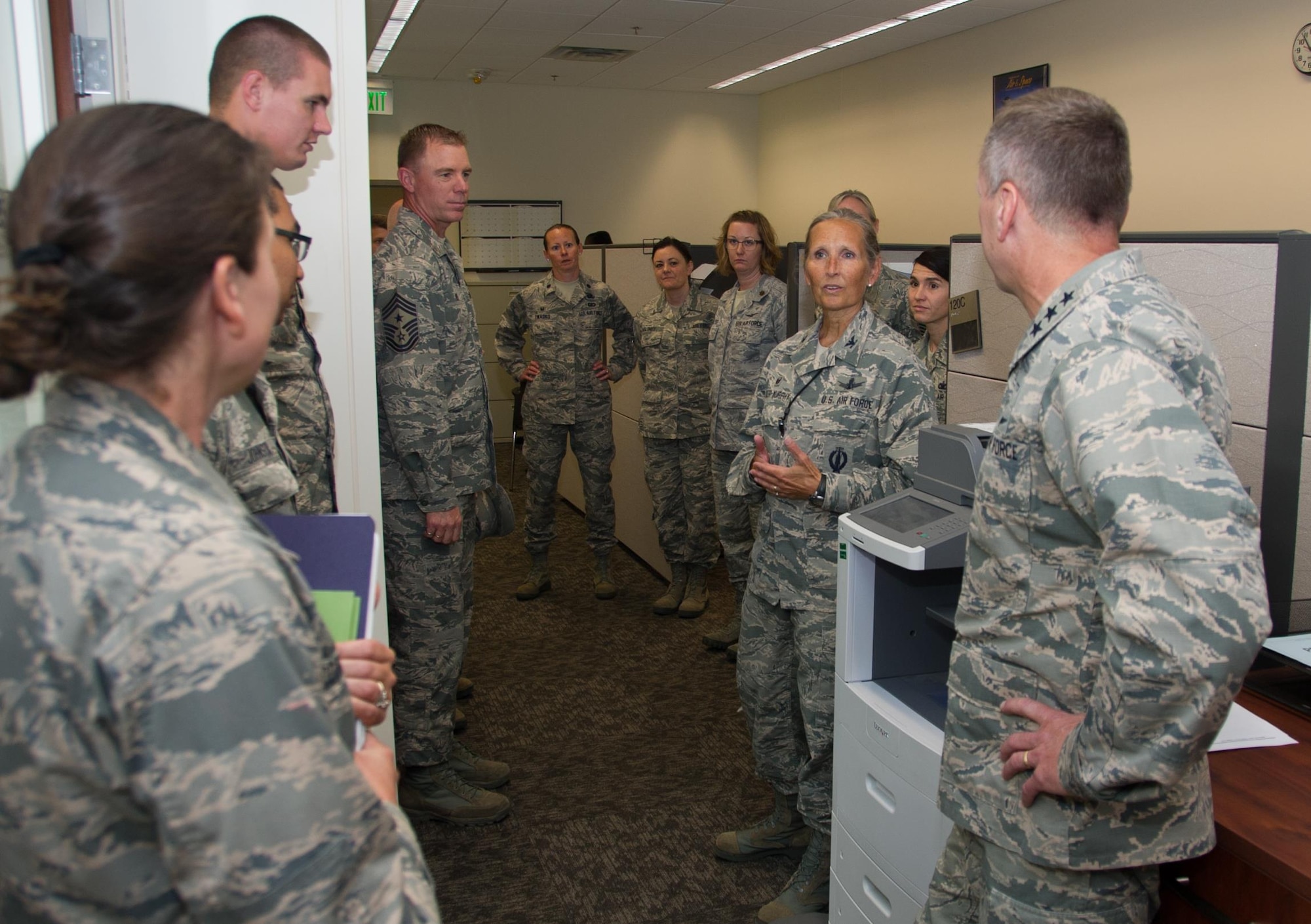 Col. Traci Kueker-Murphy, 310th Space Wing commander, speaks with Lt. Gen. David J. Buck, Commander, 14th Air Force (Air Forces Strategic), Air Force Space Command; and Commander, Joint Functional Component Command for Space, U.S. Strategic Command, about the Mission Support Group during a tour of the 310th Space Wing