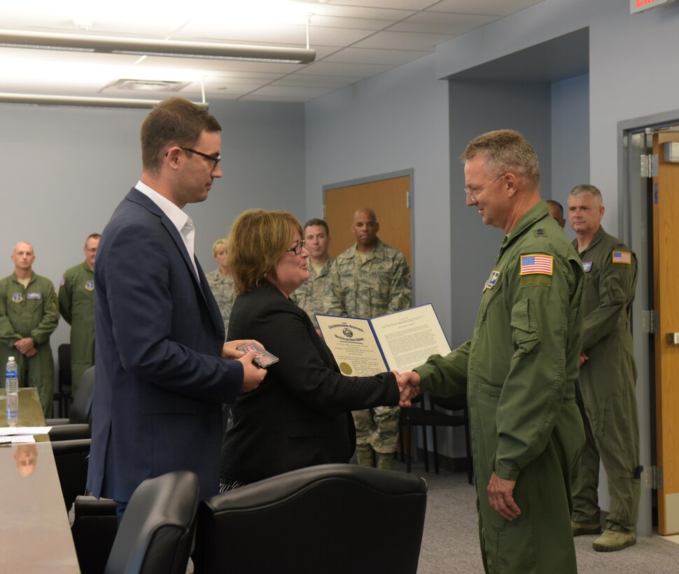 Maj. Gen. Anthony German (right), New York Adjutant General, presents Marcy and Matt Steiner with the New York State Conspicuous Service Medal awarded to the late Chuck Steiner during a dedication ceremony at Stratton Air National Guard Base, Scotia, New York, on Aug. 4, 2017. The 109th Airlift Wing's new wing conference room was dedicated to Chuck Steiner, president of the Capital Region Chamber, who passed away in April. (U.S. Air National Guard photo by Senior Master Sgt. William Gizara/Released)