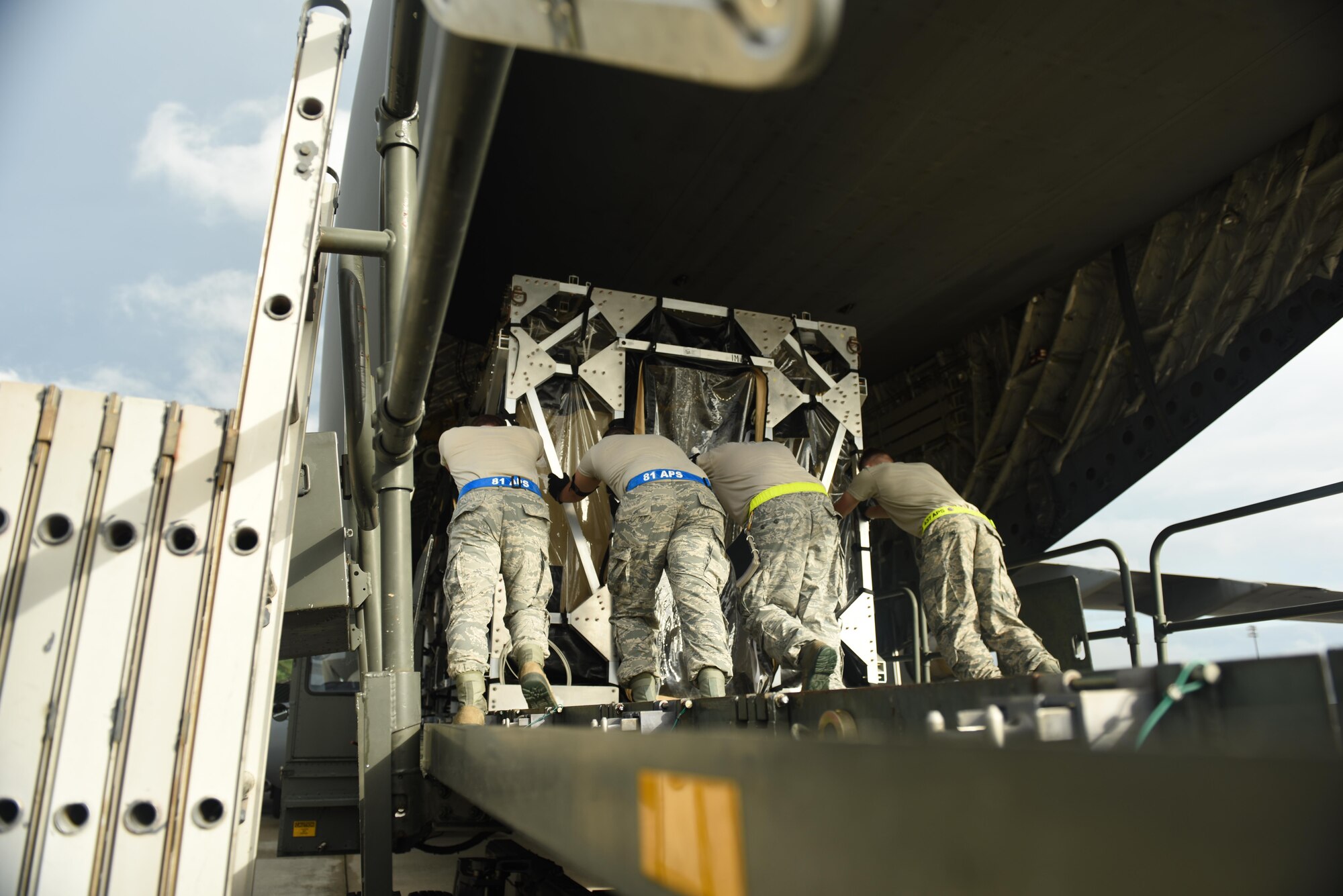 Loadmasters loading a TIS onto a C-17