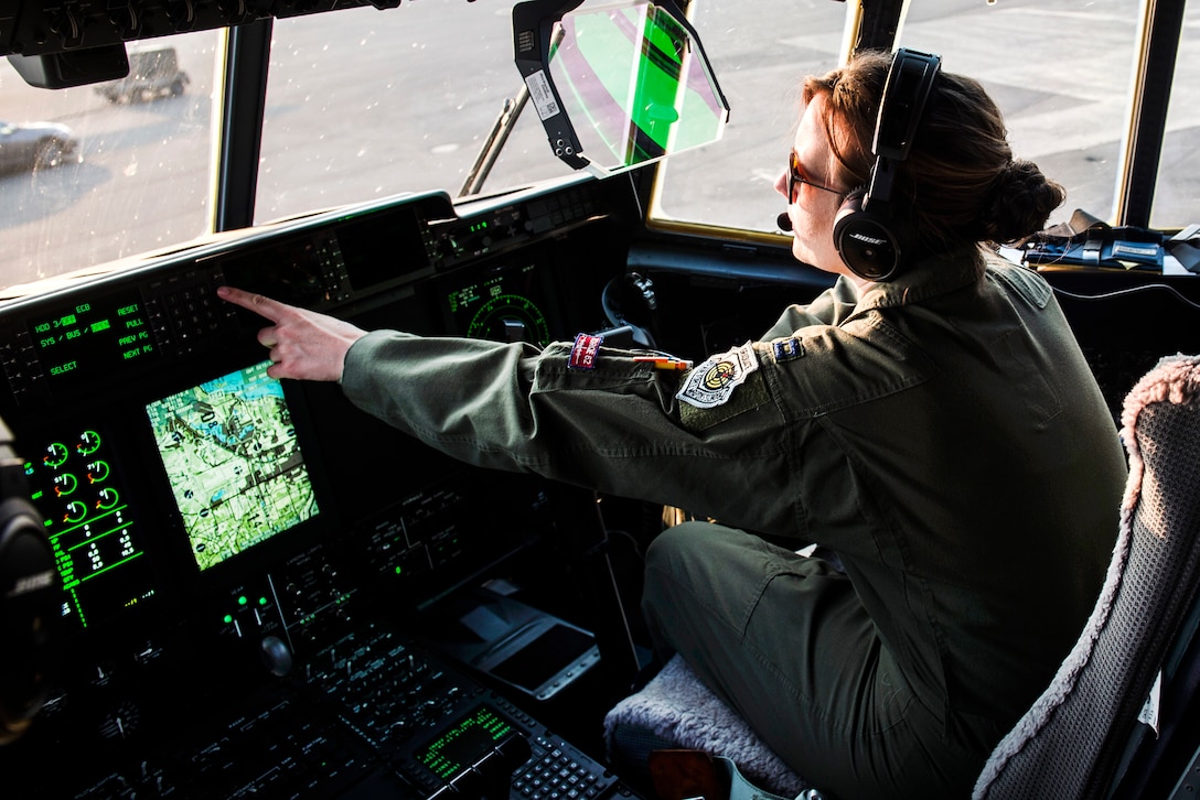A pilot  performs preflight checks aboard a C-130J Super Hercules.