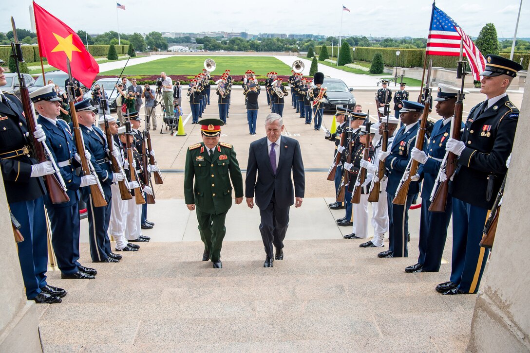 Defense Secretary Jim Mattis walks up Pentagon steps with Vietnamese counterpart.