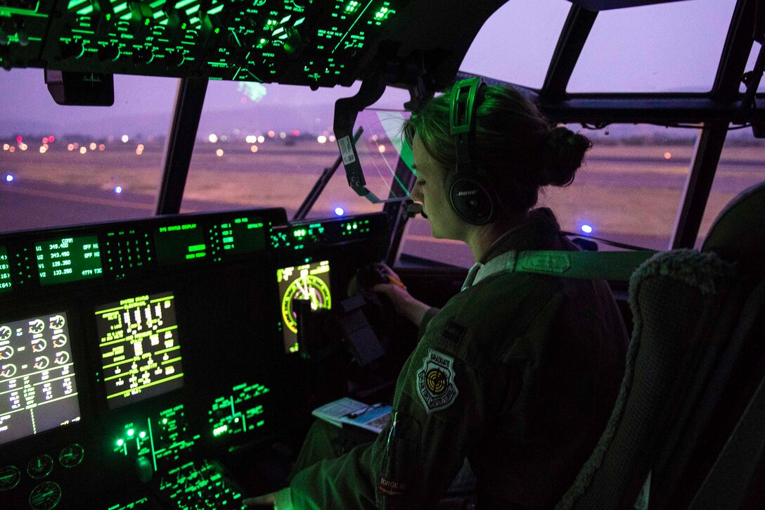 Pilot checks her instruments aboard a C-130J Super Hercules after landing.