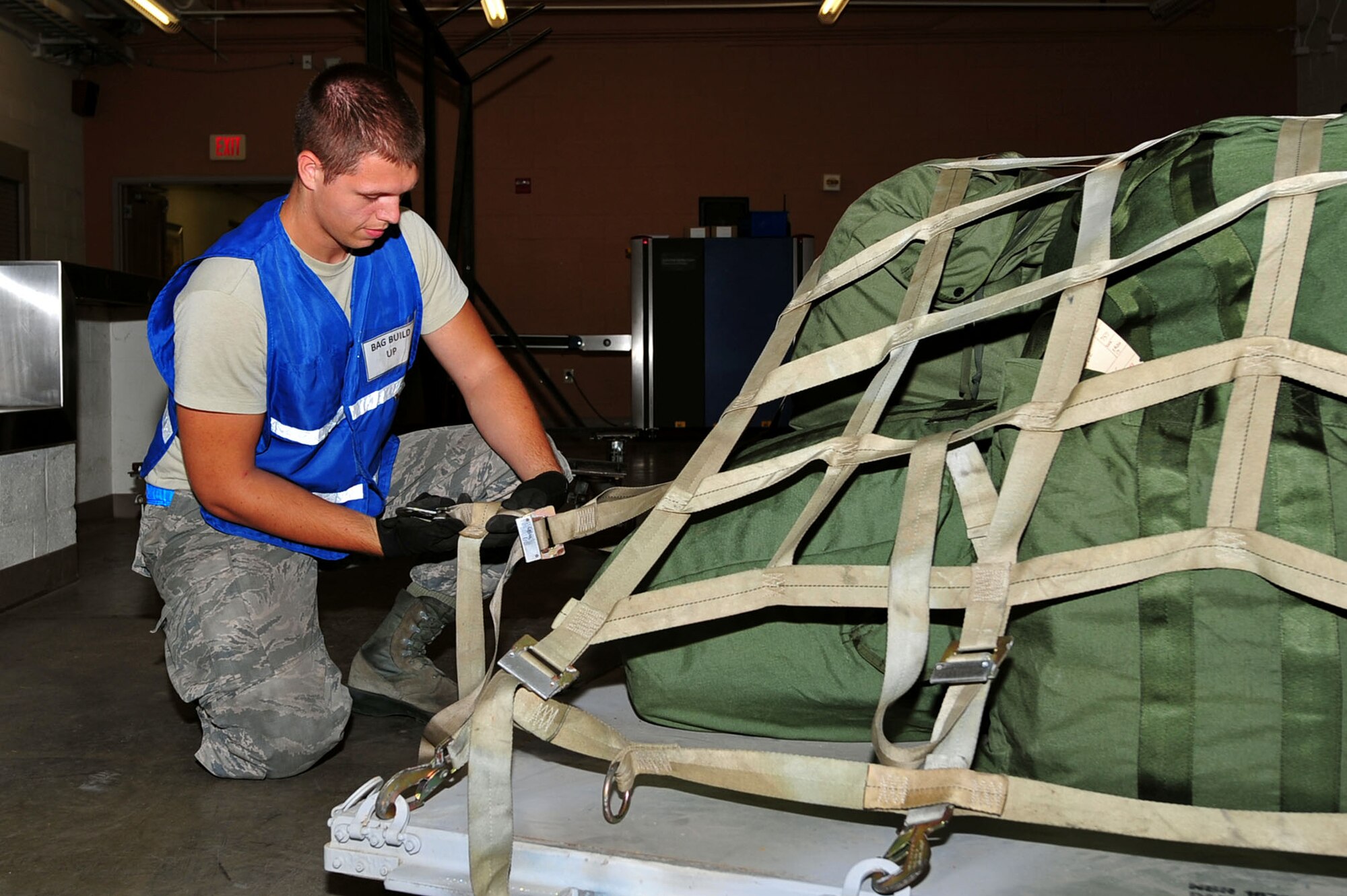 U.S. Air Force Airman 1st Class Garreth Kelsey, 20th Logistics Readiness Squadron fuels distribution operator, secures a pallet during Phase I operational readiness exercise Weasel Victory 17-08 at Shaw Air Force Base, S.C., Aug. 3, 2017. During the exercise, Airmen were evaluated on their ability to prepare and mobilize quickly for a mock deployment. (U.S. Air Force photo by Airman 1st Class Kathryn R.C. Reaves)