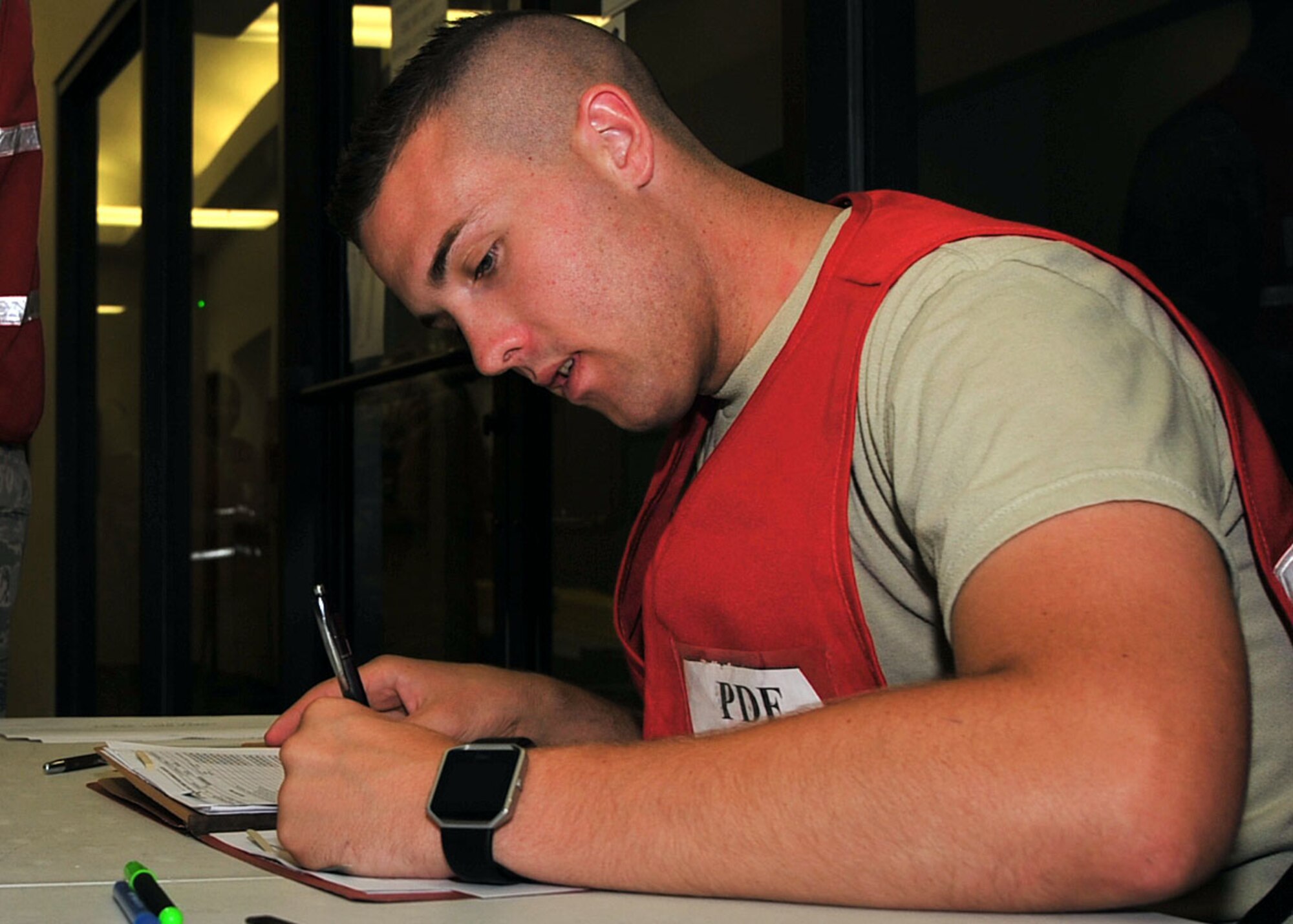 U.S. Air Force Airman 1st Class Joel Johnson, 20th Force Support Squadron relocations technician, checks a mobility folder to verify an Airman’s qualification to deploy during Phase I operational readiness exercise Weasel Victory 17-08 at Shaw Air Force Base, S.C., Aug. 3, 2017. The exercise tested the ability of 20th Fighter Wing Airmen to deploy quickly and effectively during contingency operations. (U.S. Air Force photo by Airman 1st Class Kathryn R.C. Reaves)