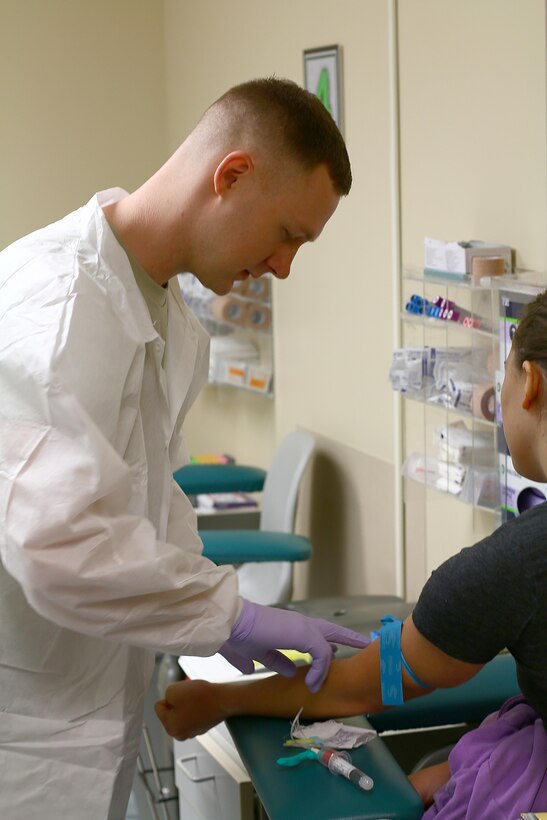 Senior Airman David Colling, 88th Dental Squadron lab technician, draws blood from Casey Smith, 445th new recruit, for a Periodic Health Assessment Services Blood Program here July 15, 2017.