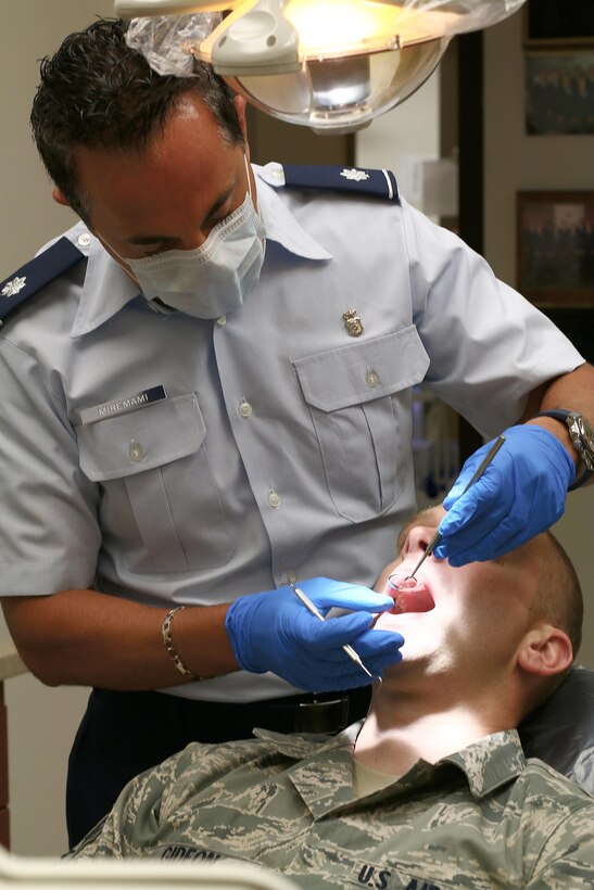 Dr. (Lt. Col.) Ali Miremami, 445th Aerospace Medicine Squadron assistant chief of dental, conducts a dental exam with Senior Airman Matthew Gideon, 445th Maintenance Squadron aircraft structural technician, as part of his Periodic Health Assessment Services Blood Program here July 15, 2017.
