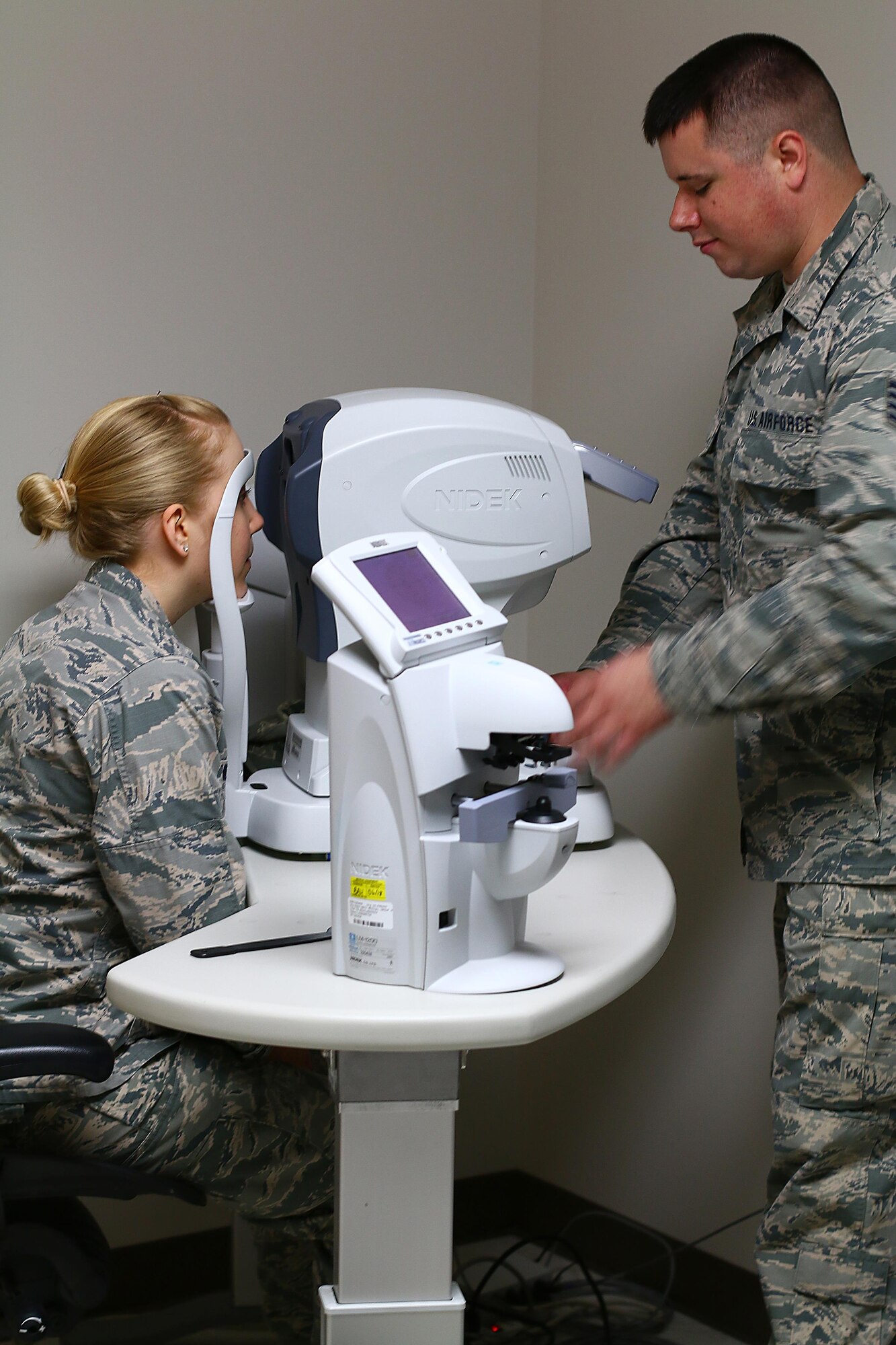 Staff Sgt. Sean Reese, 445th Aerospace Medicine Squadron optometry technician, conducts an eye exam on 2nd Lt. Sara Miles, 14th Intelligence Squadron, as part of her Periodic Health Assessment here July 15, 2017.