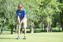 Matt Slabaugh, 74th Air Refueling Squadron assistant director of operations, prepares to putt a ball at a local golf course in Peru, Ind., July 29, 2017. The golf scramble raised money for the upcoming Air Force Ball. (U.S. Air Force photo/ Senior Airman Cali Wetli)