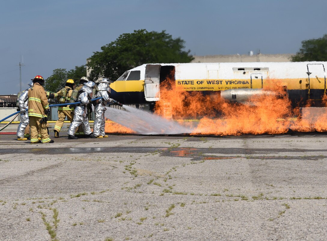 178th Wing Fire Emergency Services members practice with live fire during their annual training day at Rickenbacker Air National Guard Base in Columbus, Ohio, August 3, 2017. Annual training is required for firefighters and helps improving mission readiness. (Ohio Air National Guard photo by Airman 1st Class Anthony Le)
