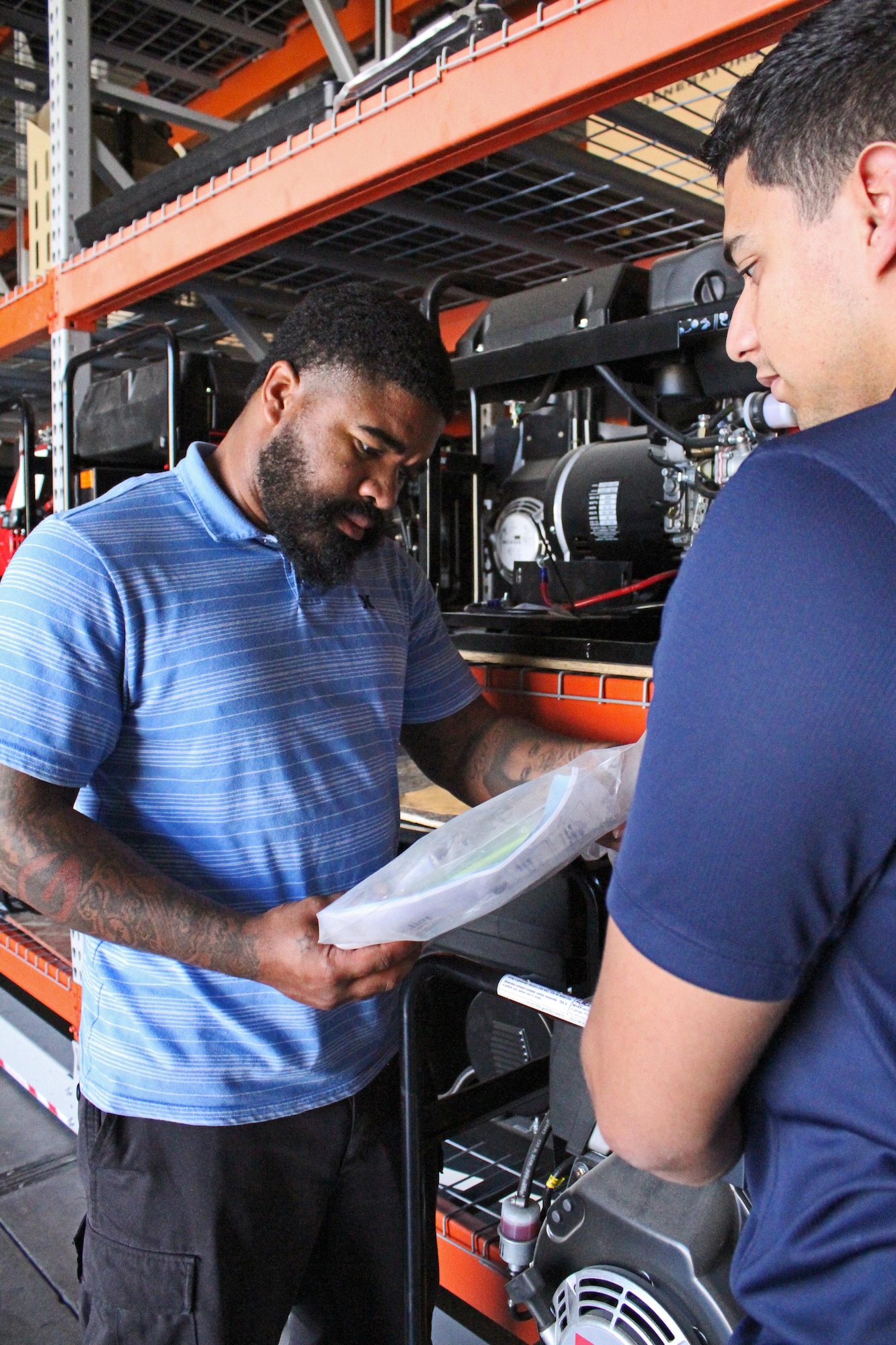 From left, Desmond Jones and David Rodriguez, members of the Air Force Security Forces Center Desert Defender Ground Combat Readiness Training Center's Logistics Detail, inventory obsolete generators.