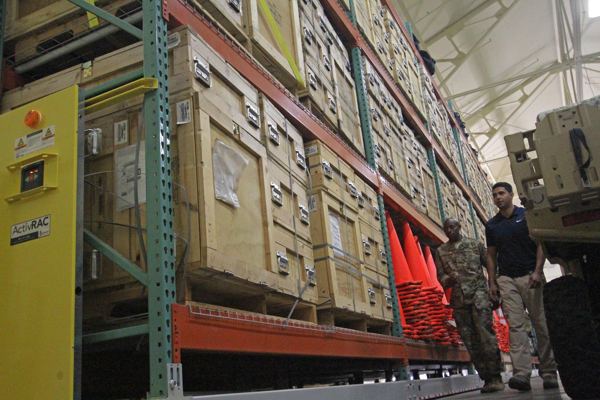 Staff Sgt. Dale Wilson and David Rodriguez, Air Force Security Forces Center Desert Defender Ground Combat Readiness Training Center Logistics Detail members, walk through one of several warehouses