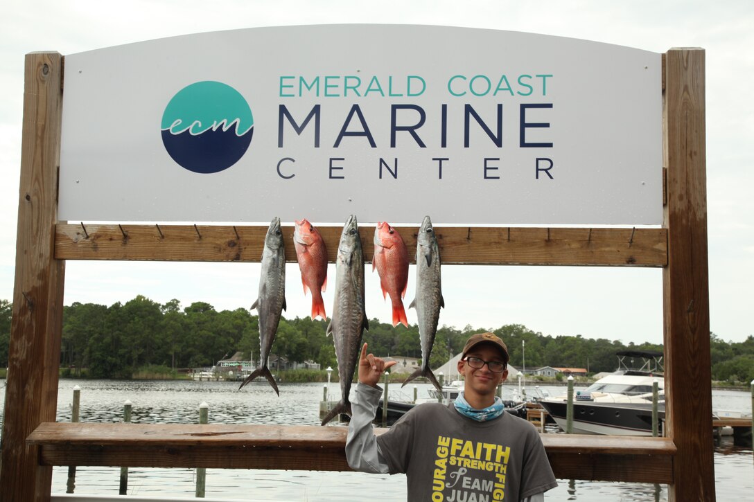 Bubba proudly displays fish he and his party caught.