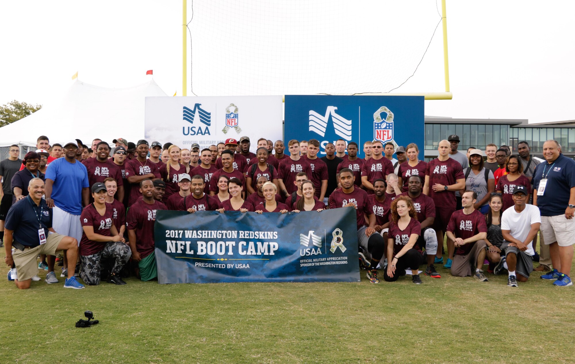 Sailors, Soldiers, Airmen and Marines pose for a group photo after completing the NFL boot camp during the Salute to Service military appreciation event at the Washington Redskins’ Bon Secours Training Camp in Richmond, Virginia, Aug. 2, 2017.