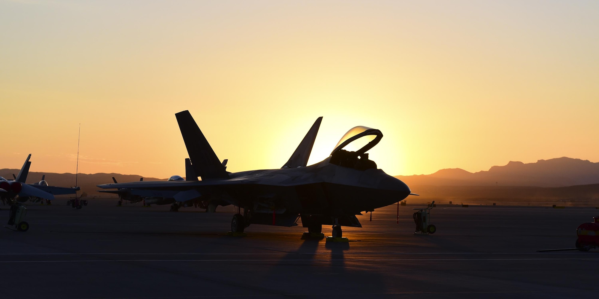 An F-22 Raptor with the 95th Fighter Squadron, Tyndall Air Force Base, Fla., is prepped for the day ahead during sunrise at Nellis Air Force Base, Nev., July 20, 2017. Raptors from Tyndall took part in the full-spectrum air combat exercise, Red Flag 17-3. This exercise allowed for more advanced integration and coordination between several Air Force, Navy and Marine units with a broad array of skillsets.