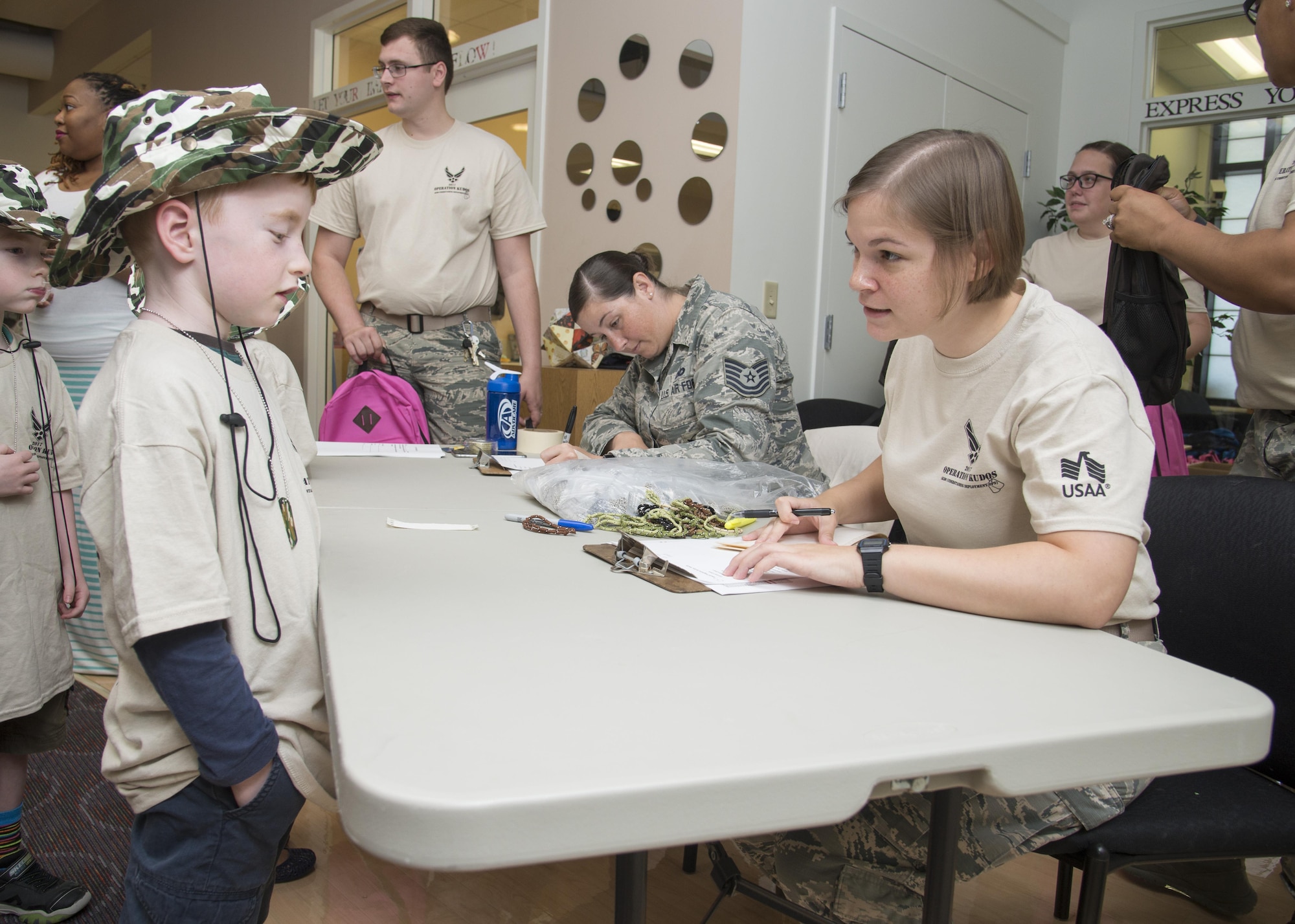 Gunner Conn, talks with 2nd Lt. Katherine Vaughn, 436th Airlift Wing Public Affairs officer, during Kids Understanding Deployment Operations Aug. 3, 2017, at the Youth Center on Dover Air Force Base, Del. Children were given “deployment” back packs and were taught about the different parts of deployment their parents go through.  (U.S. Air Force photo by Staff Sgt. Jared Duhon)
