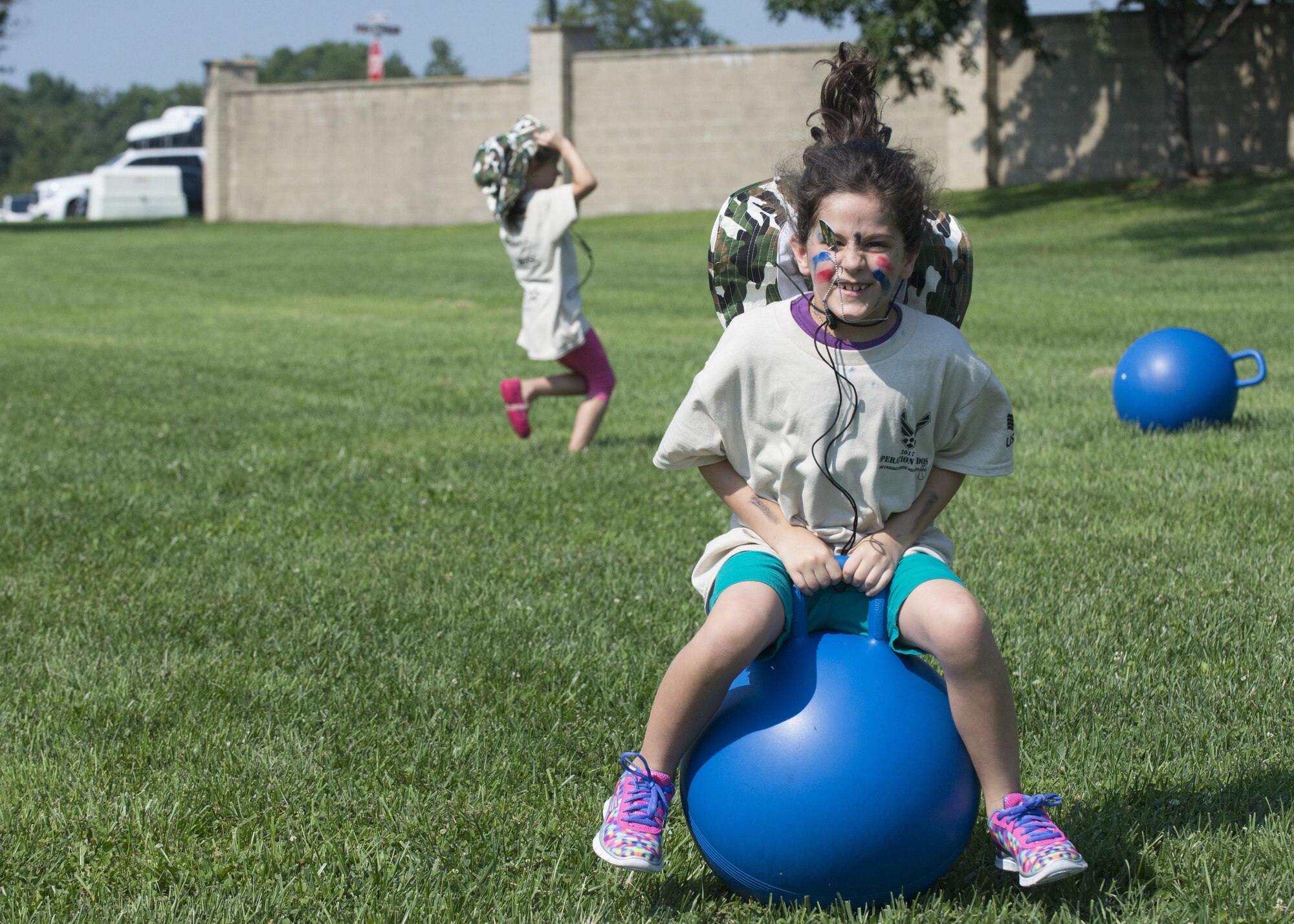 Leah Porreca, a child with the Youth Center, races to the finish line on a ball during Kids Understanding Deployment Operations Aug. 3, 2017, at the Youth Center on Dover Air Force Base, Del. The event sends kids through a simulated deployment processing line, obstacle course and other educational stations to give them a perspective on how military members prepare and process to deploy. (U.S. Air Force photo by Staff Sgt. Jared Duhon)