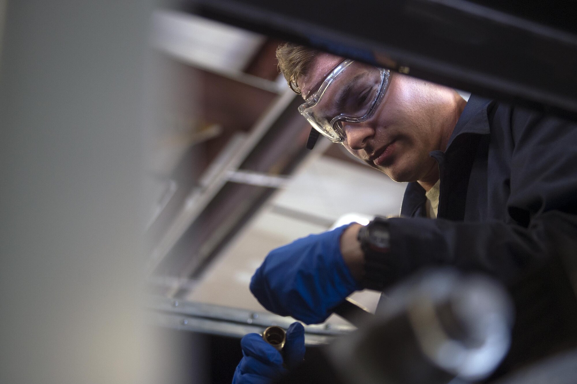 Senior Airman Kyle Saunders, 23d Wing Public Affairs broadcaster, connects fuel line components as part of the ‘A Closer Look’ video series, July 13, 2017, at Moody Air Force Base, Ga. The series shows 23d WG PA broadcasters experiencing the grit and grime of several trades for Airmen to better understand and appreciate different missions. To watch the series, stay tuned for the premier on the Moody Facebook page and www.moody.af.mil, August 15 . (U.S. Air Force photo by Senior Airman Greg Nash)