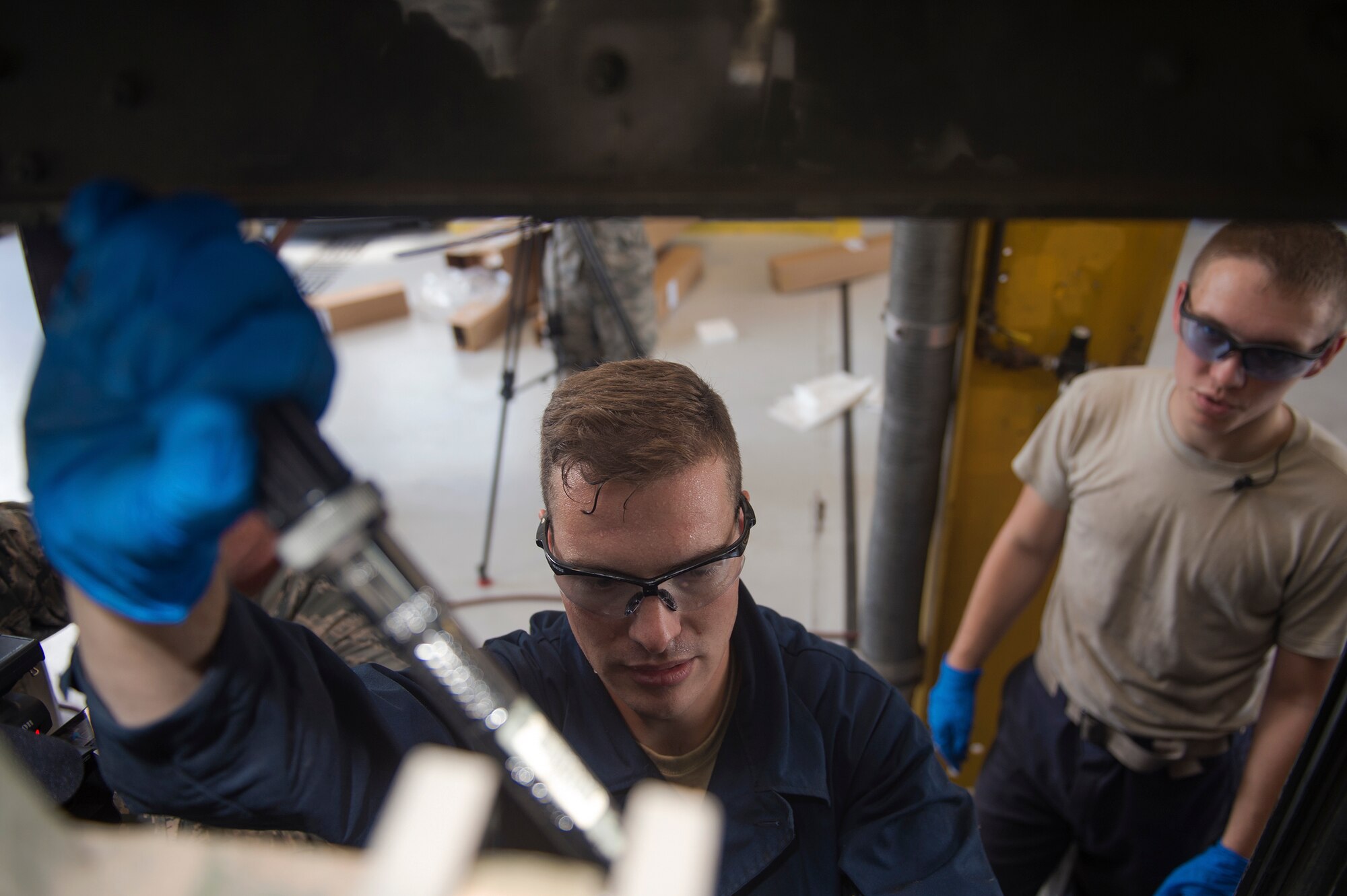 Senior Airman Kyle Saunders, 23d Wing Public Affairs broadcaster, left, receives coaching from Airman 1st Class Charles Price 23d Logistics Readiness Squadron vehicle maintenance specialist, during the ‘A Closer Look,’ video series, July 13, 2017, at Moody Air Force Base, Ga. The series shows 23d WG PA broadcasters experiencing the grit and grime of several trades for Airmen to better understand and appreciate different missions. To watch the series, stay tuned for the premier on the Moody Facebook page and www.moody.af.mil, August 15. (U.S. Air Force photo by Senior Airman Greg Nash)