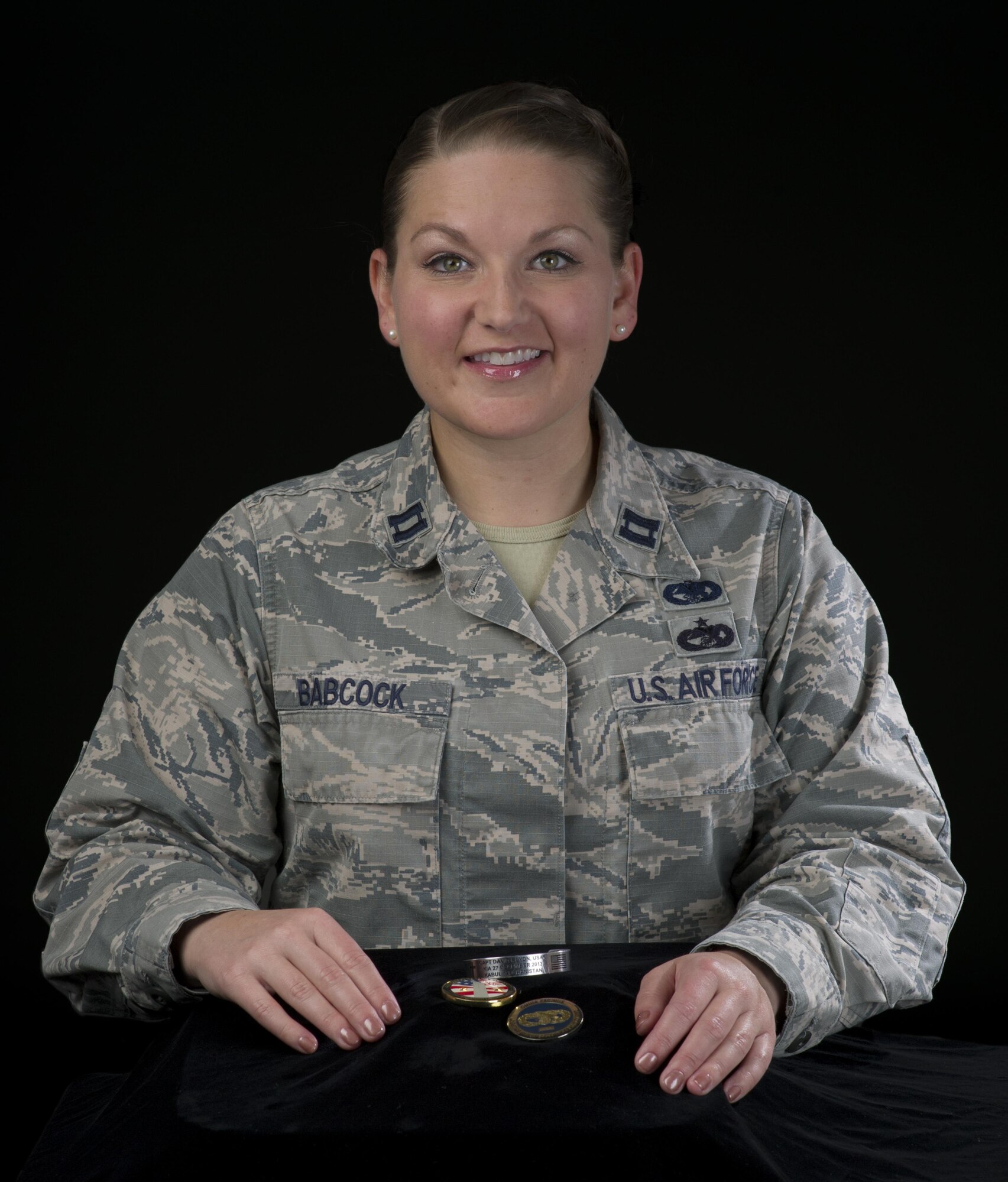 Capt. Leanne Babcock, 349th Logistics Readiness Squadron, operations officer, displays the tokens that she always keeps near, July 27, 2017 Travis Air Force Base, Calif. Men and women serving their country in all branches of the military have traditionally kept meaningful mementos or talismans close to them for good luck, as reminders, to bring comfort or other deeply felt personal reasons. (U.S. Air Force photo/ Heide Couch)